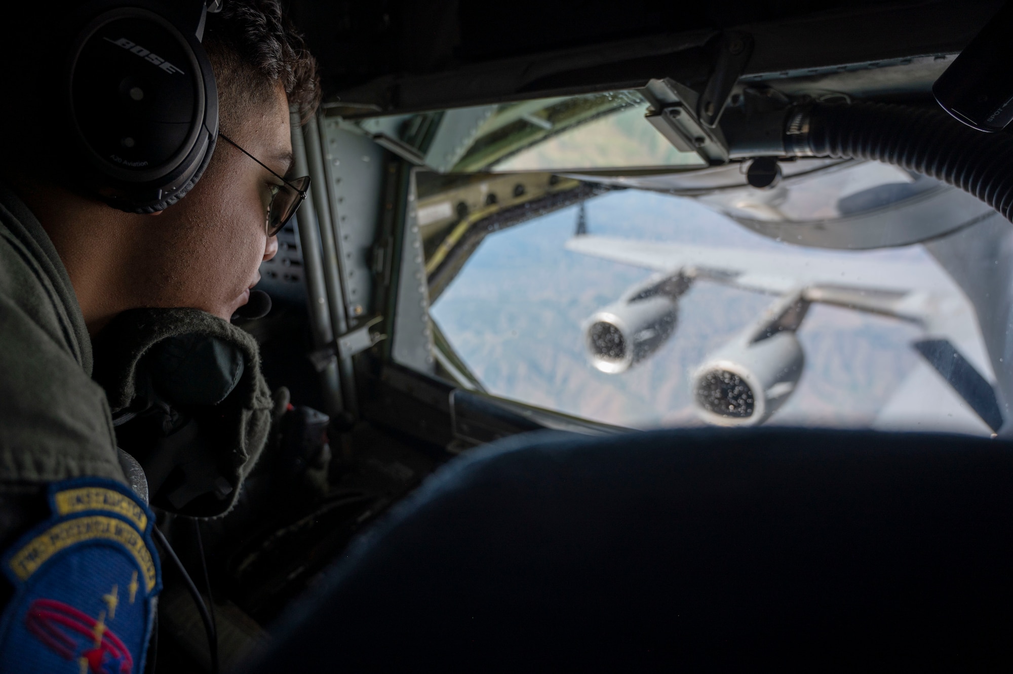 U.S. Air Force Senior Airman Aziel Alvarado, an in-flight refueling specialist assigned to the 97th Air Refueling Squadron, refuels a C-17 Globemaster III from Fairchild Air Force Base, Washington, June 22, 2023. Alvarado participated in a Pride flight that honors the diverse backgrounds and strengths that the lesbian, gay, bisexual, trans, queer, plus Airmen bring to the Fairchild mission. (U.S. Air Force photo by Airman 1st Class Lillian Patterson)