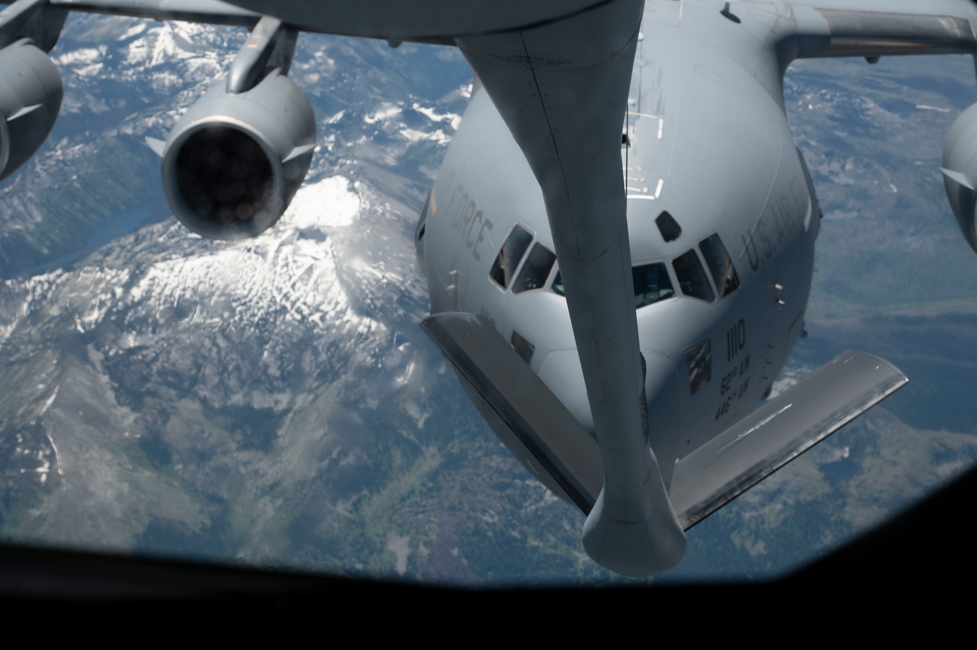 A KC-135 Stratotanker refuels a C-17 Globemaster III during a Pride flight from Fairchild Air Force Base, Washington, June 22, 2023. Airmen participated in a Pride flight that honors the diverse backgrounds and strengths that the lesbian, gay, bisexual, trans, queer, plus Airmen bring to the Fairchild mission. (U.S. Air Force photo by Airman 1st Class Lillian Patterson)