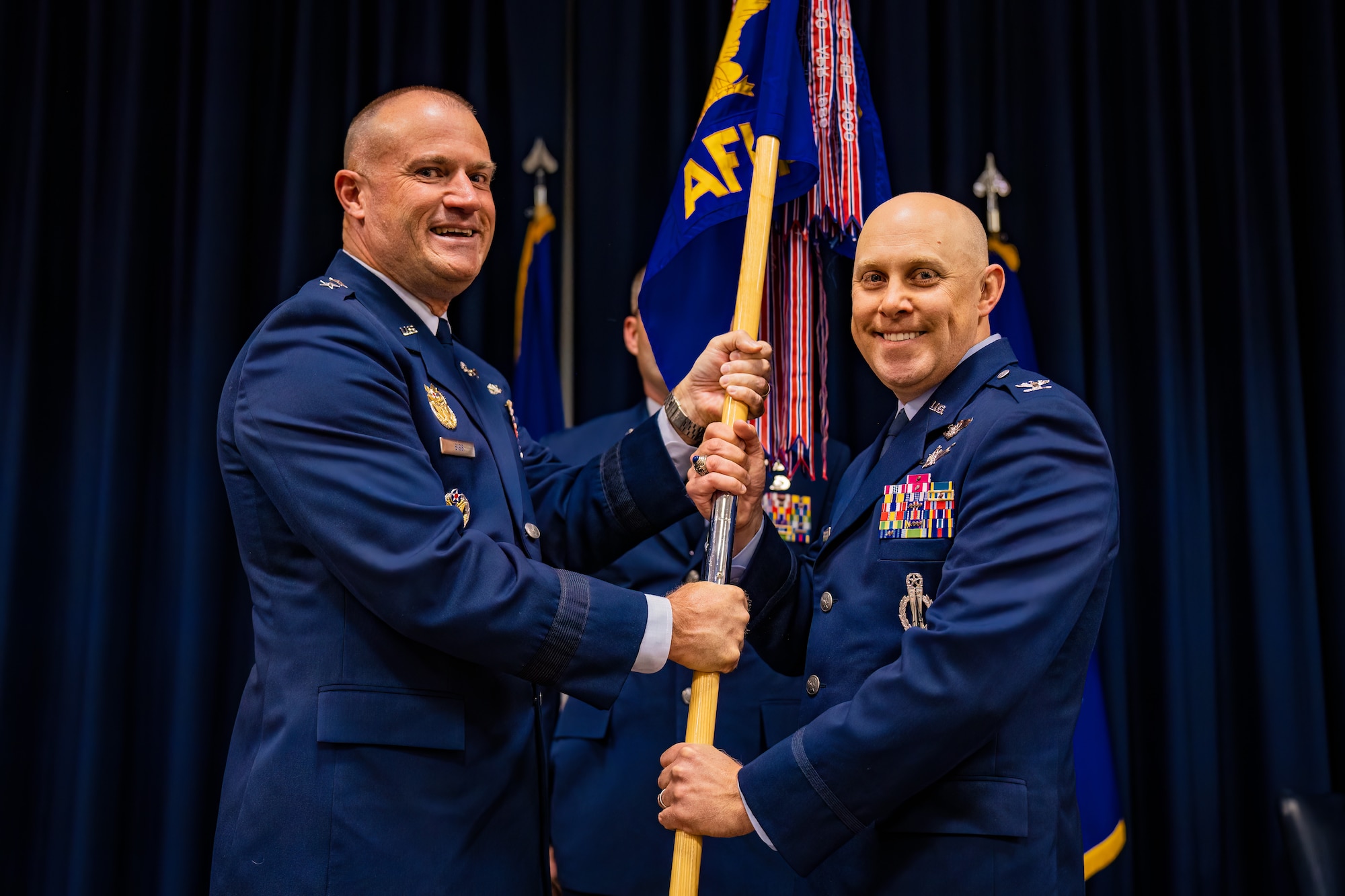 Two men hold a flag
