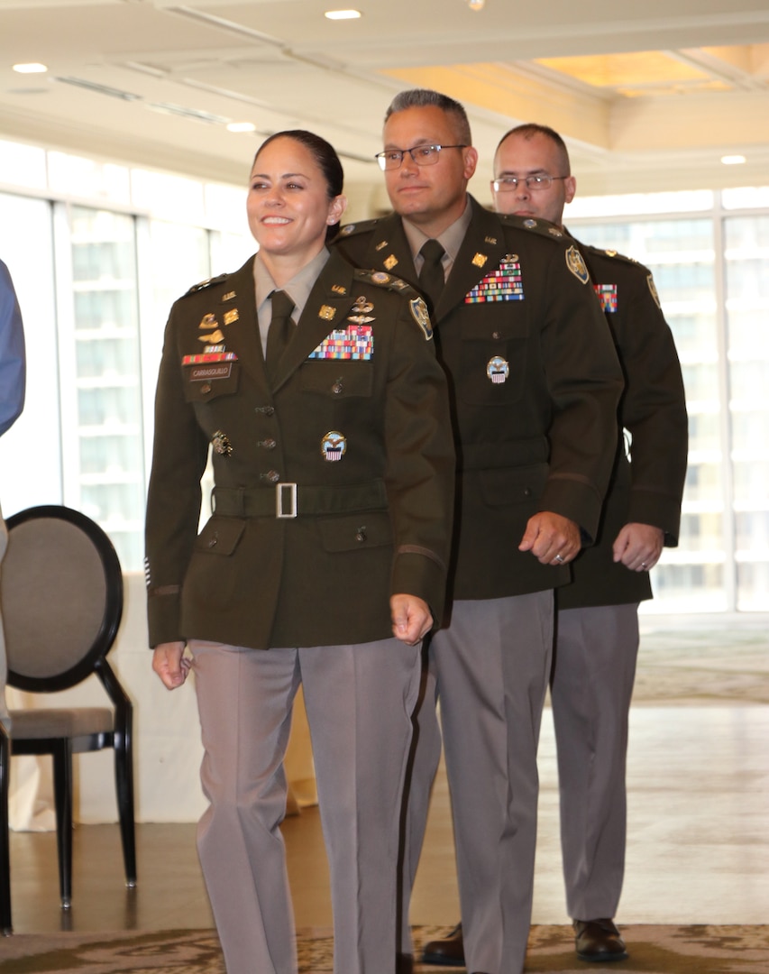 three members in uniform walking
