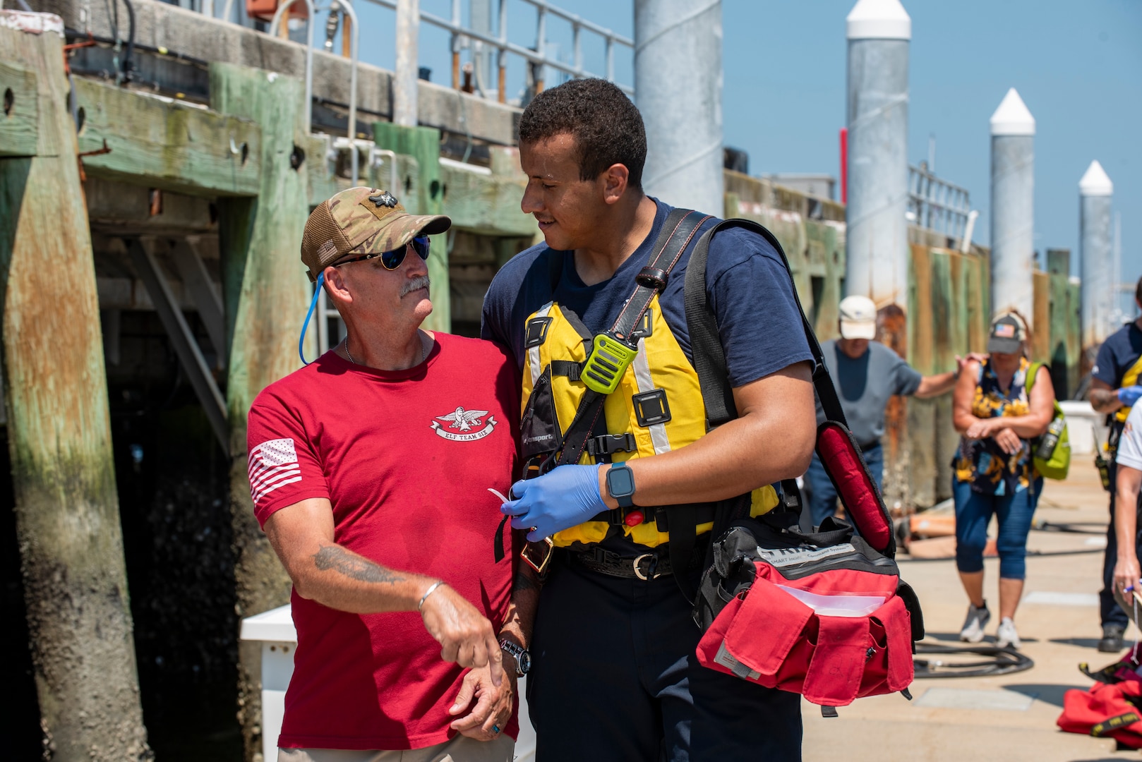 A Charleston Fire Department crew member assists a mock survivor during a mass rescue exercise at Station Charleston in Charleston, South Carolina, June 28, 2023.