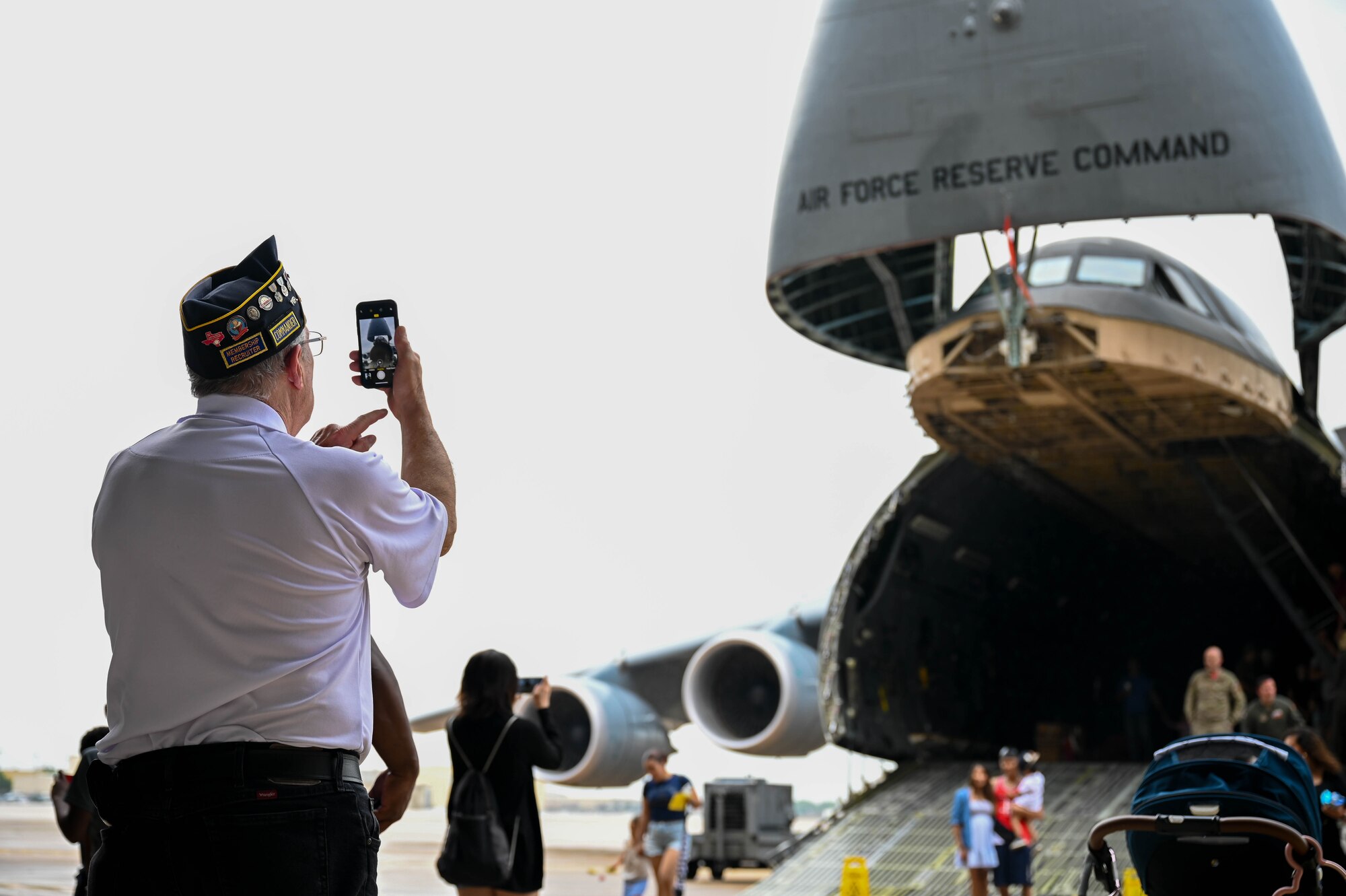 A veteran member from the Veterans of Foreign Wars takes a photo of a C-5M Super Galaxy aircraft static during the 433rd Airlift Wing Family Day at Joint Base San Antonio-Lackland, Texas, May 7, 2023. A C-5M Super Galaxy aircraft was opened for public display during the event. (U.S. Air Force photo by Senior Airman Mark Colmenares)