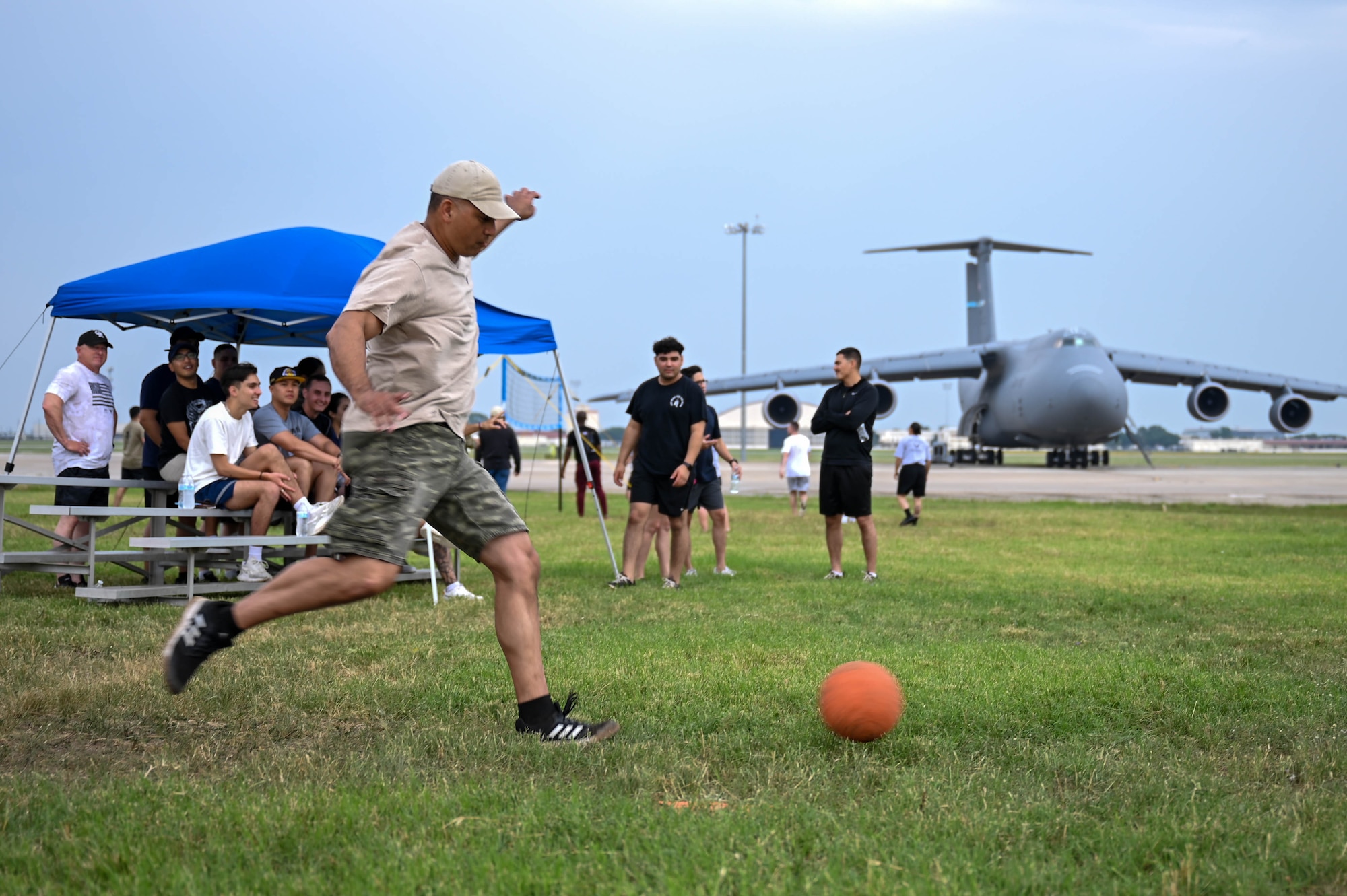 Tech. Sgt. Jeremy Luera, 433rd Maintenance Squadron aerospace ground equipment technician, runs to kick a ball during the Alamo Rising 6 annual kickball tournament at Joint Base San Antonio-Lackland, Texas, May 7, 2023. The kickball tournament was one of several activities at 433rd Airlift Wing Family Day. (U.S. Air Force photo by Senior Airman Mark Colmenares)