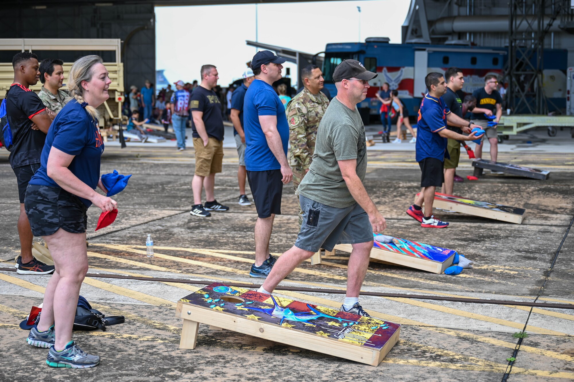 Reserve Citizen Airmen and their families compete in a cornhole tournament during 433rd Airlift Wing Family Day at Joint Base San Antonio-Lackland, Texas, May 7, 2023. The cornhole tournament was one of several activities at Family Day. (U.S. Air Force photo by Senior Airman Mark Colmenares)