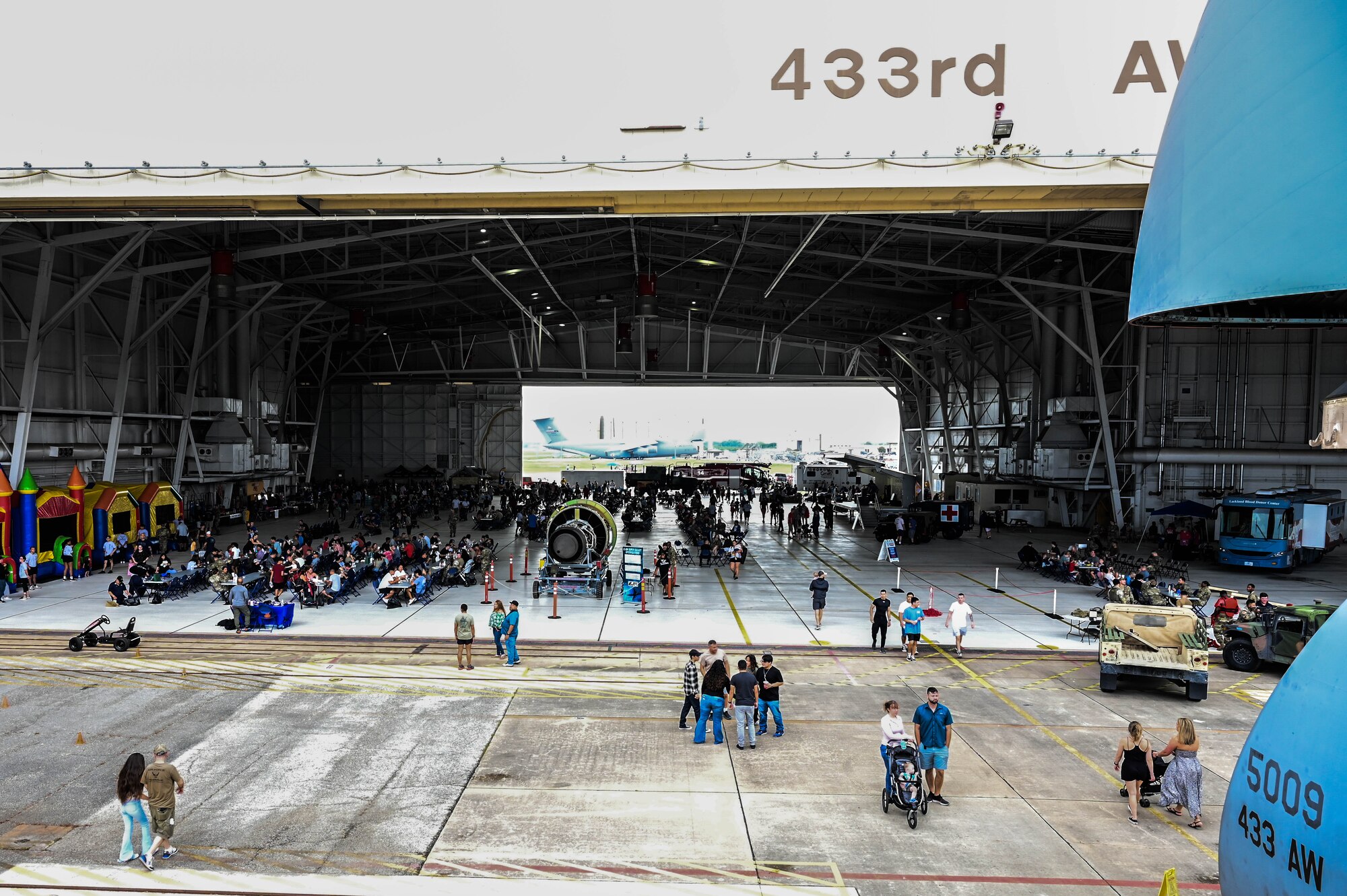 Reserve Citizen Airmen and their families participate in the 433rd Airlift Wing Family Day May 7, 2023, at Joint Base San Antonio-Lackland, Texas. A C-5M Super Galaxy aircraft was opened for public display during the event. (U.S. Air Force photo by Senior Airman Mark Colmenares)