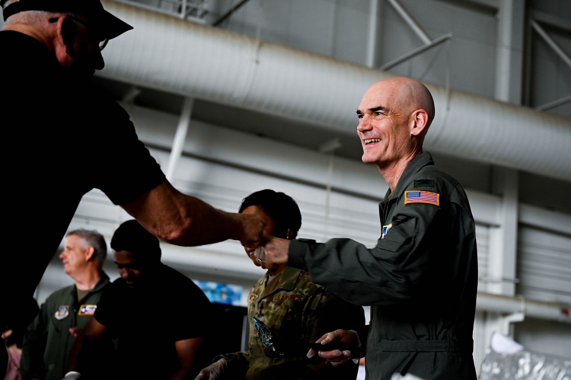 Col. William Gutermuth, 433rd Airlift Wing commander, greets a member of the Alamo Wing community during 433rd Airlift Wing Family Day at Joint Base San Antonio-Lackland, Texas, May 7, 2023. The event provided an opportunity for families to join their Reserve Citizen Airmen at work and see more of the unit's mission. (U.S. Air Force photo by Senior Airman Mark Colmenares)
