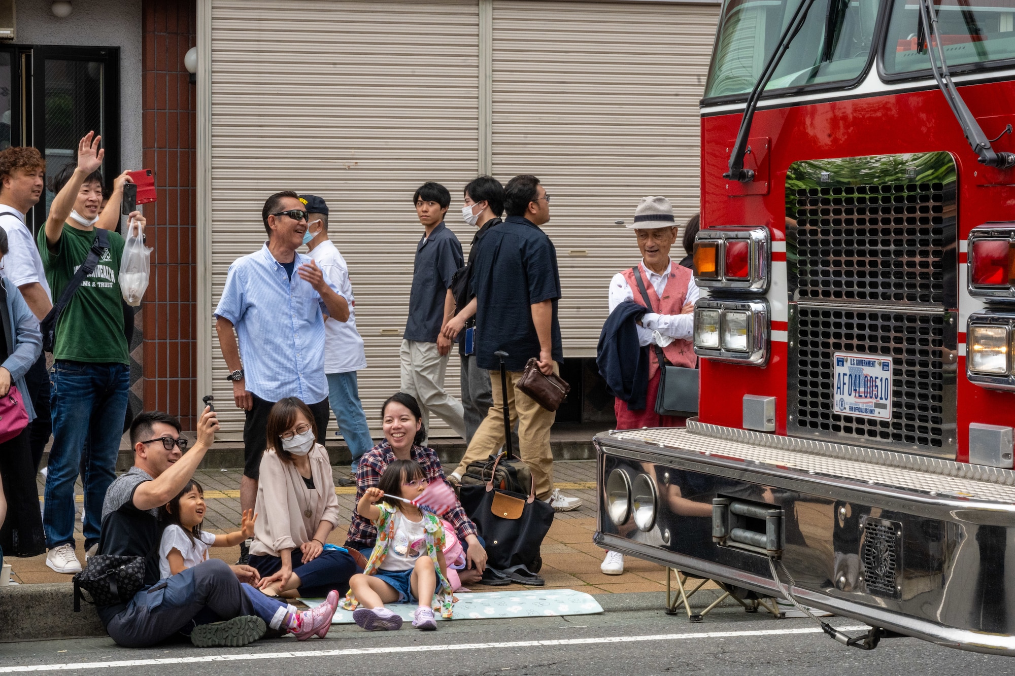 Japanese and American kids line the streets to wave at a U.S. Air Force fire truck during the American Day parade in Misawa City, Japan, June 25, 2023. Events like these are important as they afford Misawa’s local community, American and Japanese alike, opportunities to interact in a relaxed environment meant to build friendships and strengthen partnerships. (U.S. Air Force photo by Staff Sgt. Kristen Heller)
