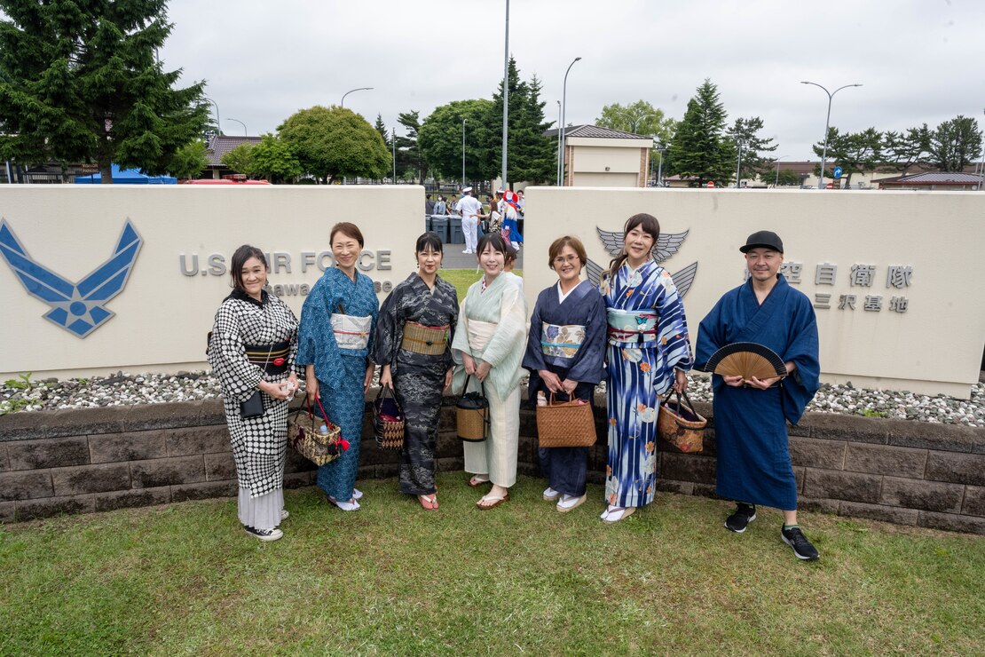 Japanese attendees dressed in yukatas pose for a photo in front of the Misawa Air Base signs in Misawa City, Japan, June 25, 2023. American Day is one of the largest cross-cultural festivals in the area and it made a return after being on hiatus due to COVID-19. The event, drawing over 50,000 visitors, took on the theme “two cultures, but one community.” (U.S. Air Force photo by Staff Sgt. Kristen Heller)
