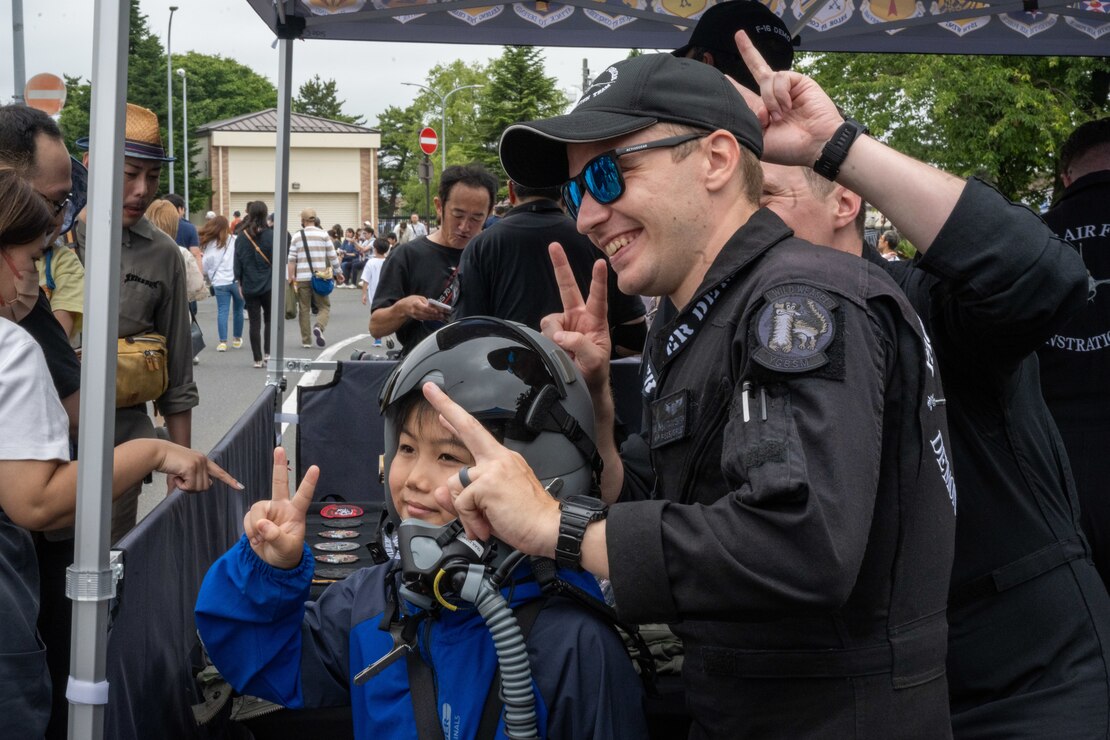 Members of the PACAF F-16 Demonstration Team pose for a photo with a Japanese attendee of American Day in Misawa City, Japan, June 25, 2023. American Day is one of the largest cross-cultural festivals in the area and it made a return after being on hiatus due to COVID-19. The event, drawing over 50,000 visitors, took on the theme “two cultures, but one community.” (U.S. Air Force photo by Staff Sgt. Kristen Heller)