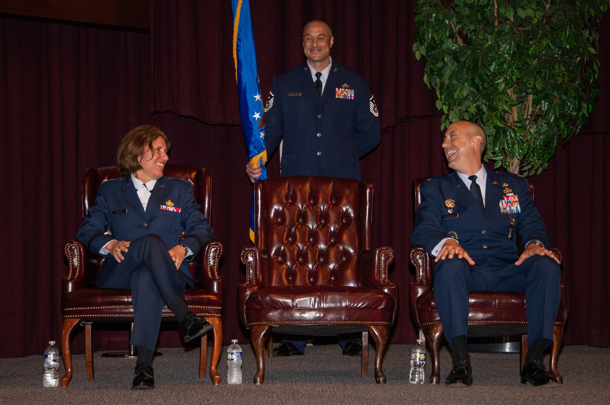 Left to right, Lt. Gen. Andrea D. Tullo, Master Sgt. William Jenkins and Col. Damian Schlussel laugh at a joke made by Col. Anthony D. Babcock as he gives his final remarks as commander before relinquishing command of the Thomas N. Barnes Center for Enlisted Education to Schlussel during a change of command ceremony at the Senior Noncommissioned Officer Academy on Maxwell Air Force Base - Gunter Annex, June 28, 2023. Tullos is the Air University commander and president, and Jenkins is the Barnes Center first sergeant.  (U.S. Air Force photo/Brian Ferguson)
