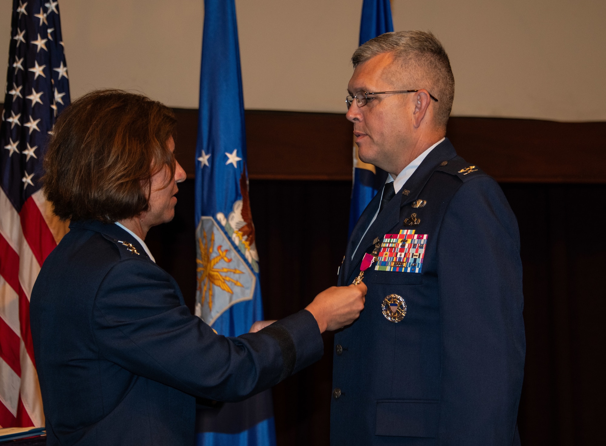Col. Anthony D. Babcock receives the Legion of Merit medal, second oak leaf cluster, from Lt. Gen. Andrea D. Tullos, Air University commander and president, during the Thomas N. Barnes Center for Enlisted Education change of command ceremony at the Senior Noncommissioned Officer Academy on Maxwell Air Force Base - Gunter Annex, June 28, 2023. During the ceremony, Babcock relinquished command of the Barnes Center to Col. Damian Schlussel. (U.S. Air Force photo/Brian Ferguson)