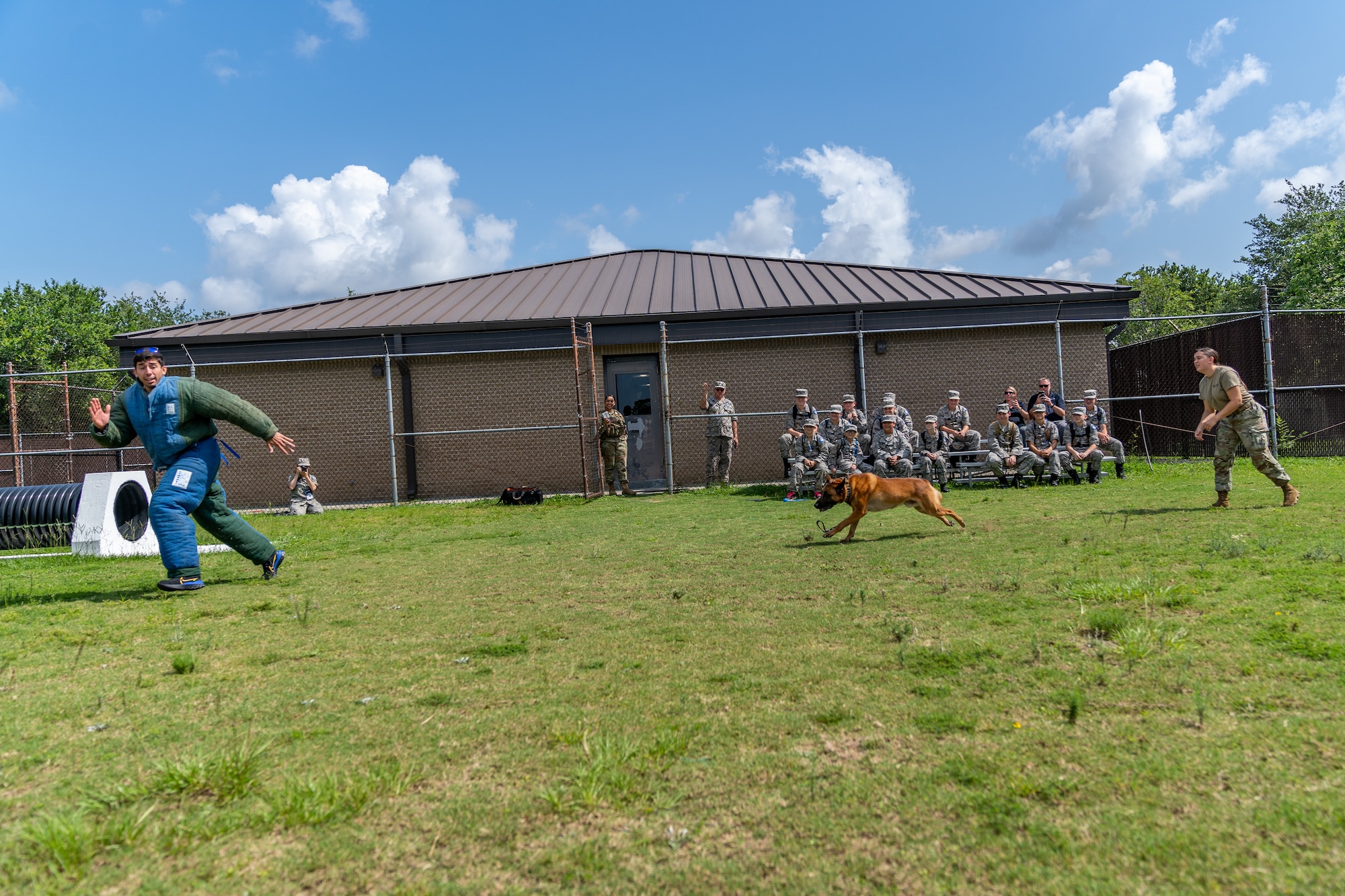 U.S. Air Force Staff Sgt. Anthony Seretis, 81st Security Forces Squadron military working dog trainer, runs from Victor, 81st SFS military working dog during a demonstration for the Louisiana Civil Air Patrol Encampment at Keesler Air Force Base, Mississippi, June 23, 2023.