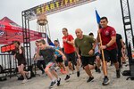 433rd Airlift Wing members and family run past the starting line during the San Antonio Port Dawg Memorial Run and Family Day fun run at Joint Base San Antonio-Lackland, Texas, May 7, 2023. 433rd AW reservists and family members had the option to complete either a 1.5-mile run, a 5k run or a virtual 5k run. (U.S. Air Force photo by Senior Airman Mark Colmenares)