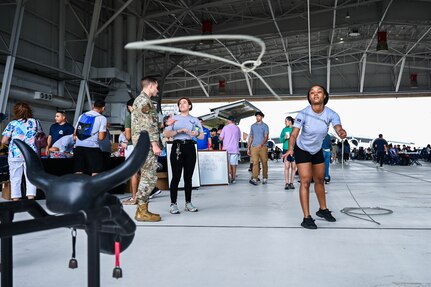 Tortavion Jamerson-Goode, 433rd Development & Training Flight member, throws a lasso at a roping steer head during 433rd Airlift Wing Family Day at Joint Base San Antonio-Lackland, Texas, May 7, 2023. The roping steer head booth was one of several activities at Family Day. (U.S. Air Force photo by Senior Airman Mark Colmenares)