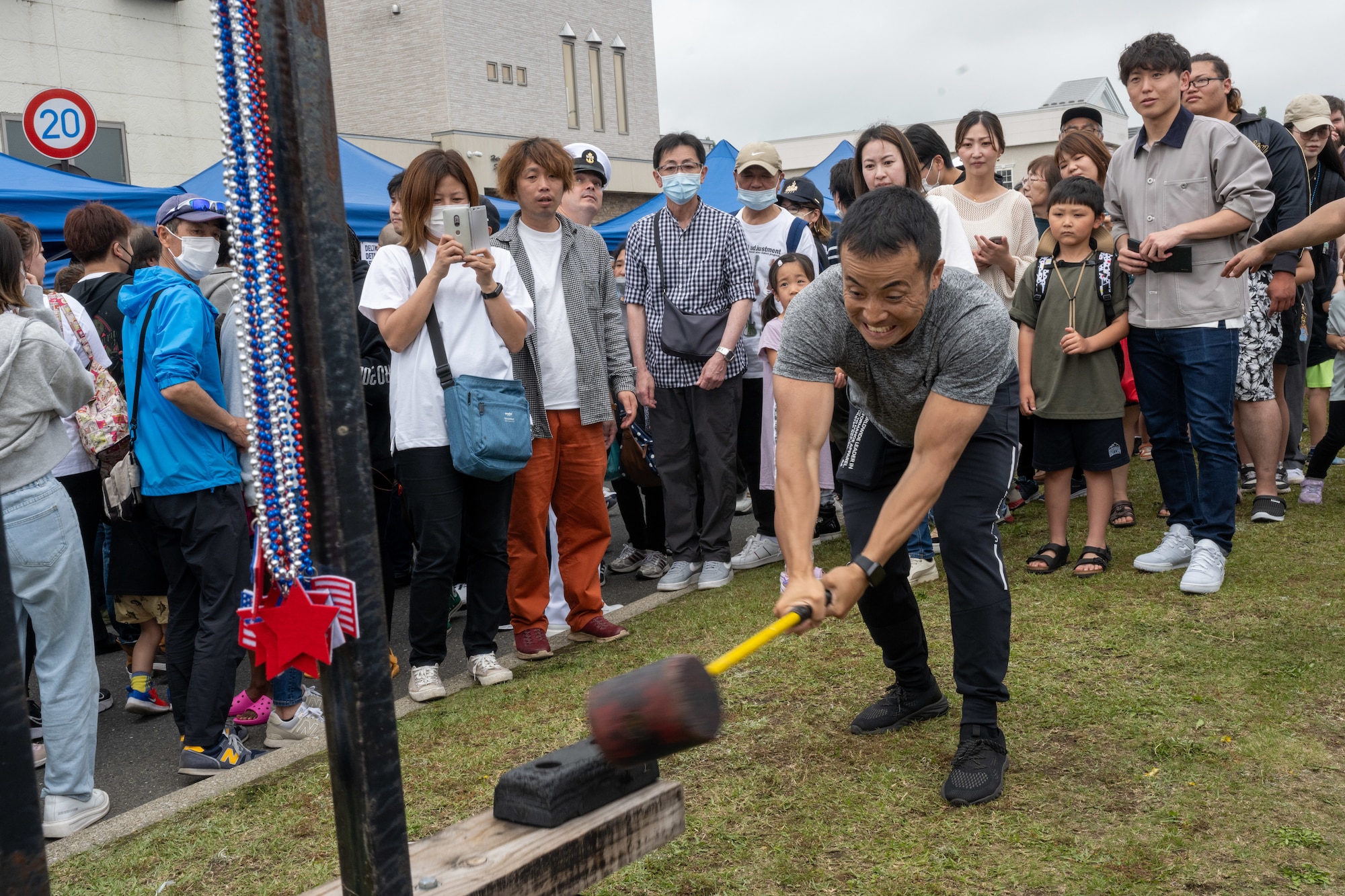 An attendee of American Day plays high striker in Misawa City, Japan, June 25, 2023. Events like these are important as they afford Misawa’s local community, American and Japanese alike, opportunities to interact in a relaxed environment meant to build friendships and strengthen partnerships. (U.S. Air Force photo by Staff Sgt. Kristen Heller)