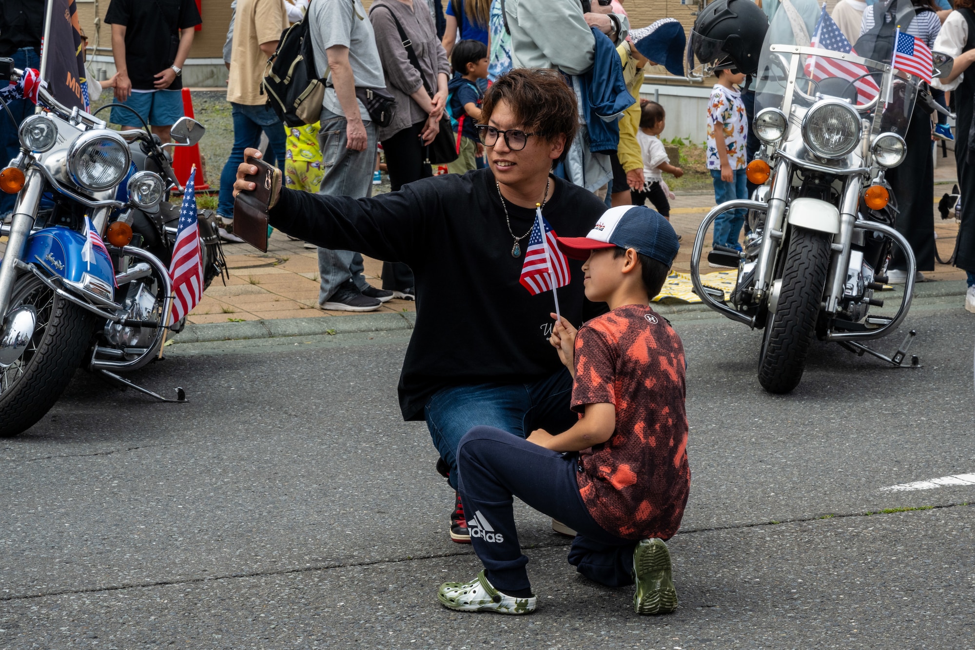 Japanese attendees of American Day take a photo on the main street after the parade in Misawa City, Japan, June 25, 2023. American Day is one of the largest cross-cultural festivals in the area and it made a return after being on hiatus due to COVID-19. The event, drawing over 50,000 visitors, took on the theme “two cultures, but one community.” (U.S. Air Force photo by Staff Sgt. Kristen Heller)