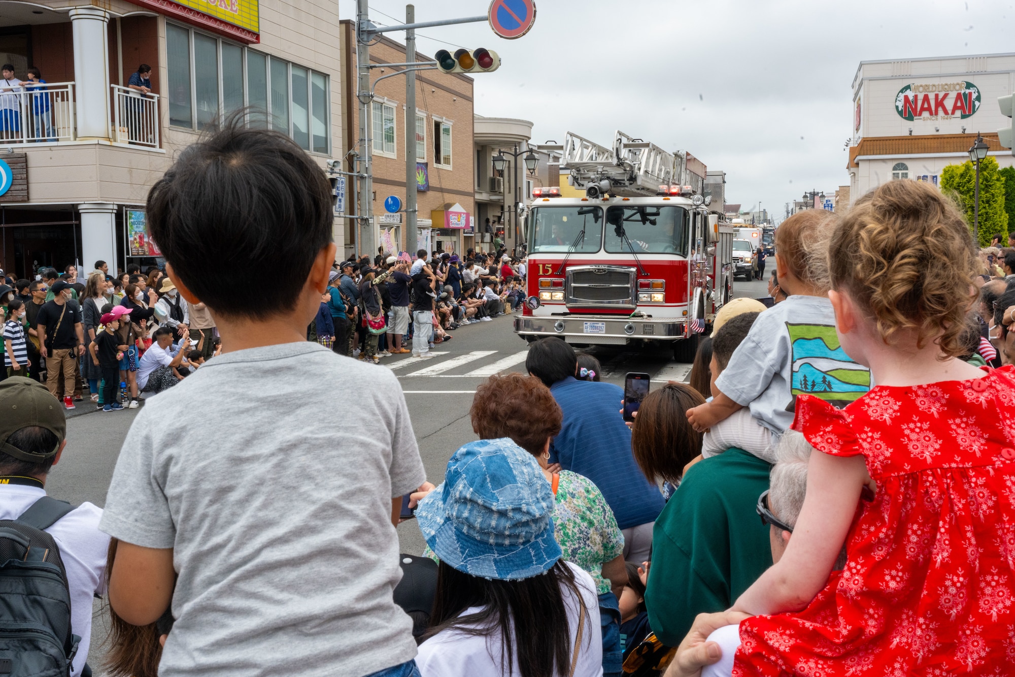 Japanese and American kids admire a fire truck during the American Day parade in Misawa City, Japan, June 25, 2023. American Day is one of the largest cross-cultural festivals in the area and it made a return after being on hiatus due to COVID-19. The event, drawing over 50,000 visitors, took on the theme “two cultures, but one community.” (U.S. Air Force photo by Staff Sgt. Kristen Heller)