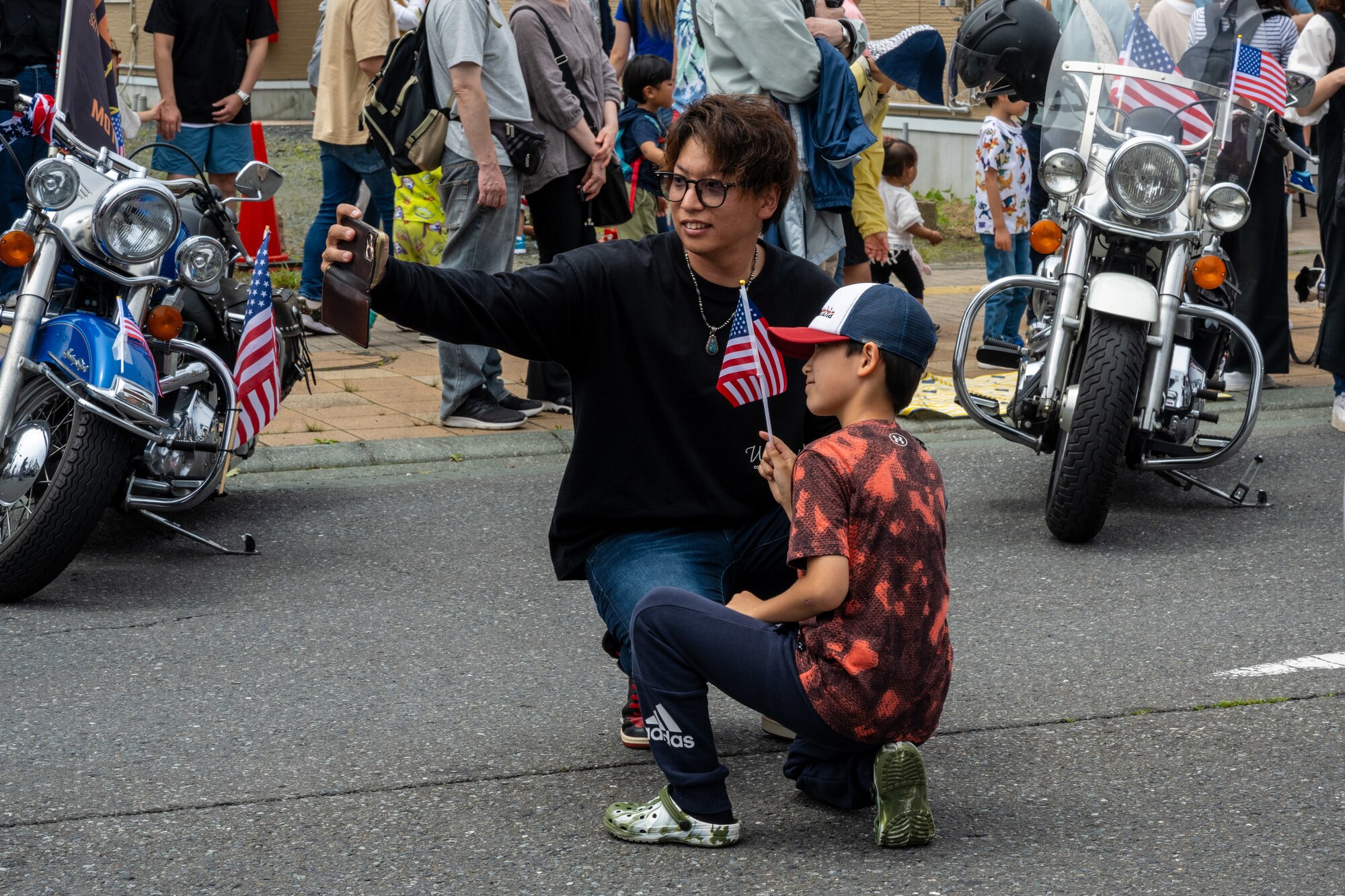 Japanese attendees of American Day take a photo on the main street after the parade in Misawa City, Japan, June 25, 2023. American Day is one of the largest cross-cultural festivals in the area and it made a return after being on hiatus due to COVID-19. The event, drawing over 50,000 visitors, took on the theme “two cultures, but one community.” (U.S. Air Force photo by Staff Sgt. Kristen Heller)