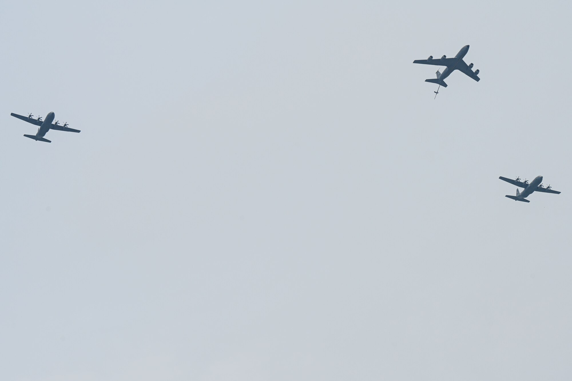 Two C-130J Super Hercules from the 19th Airlift Wing fly alongside a KC-135R from Key Field Air National Guard Bas, Mississippi, over Arkansas