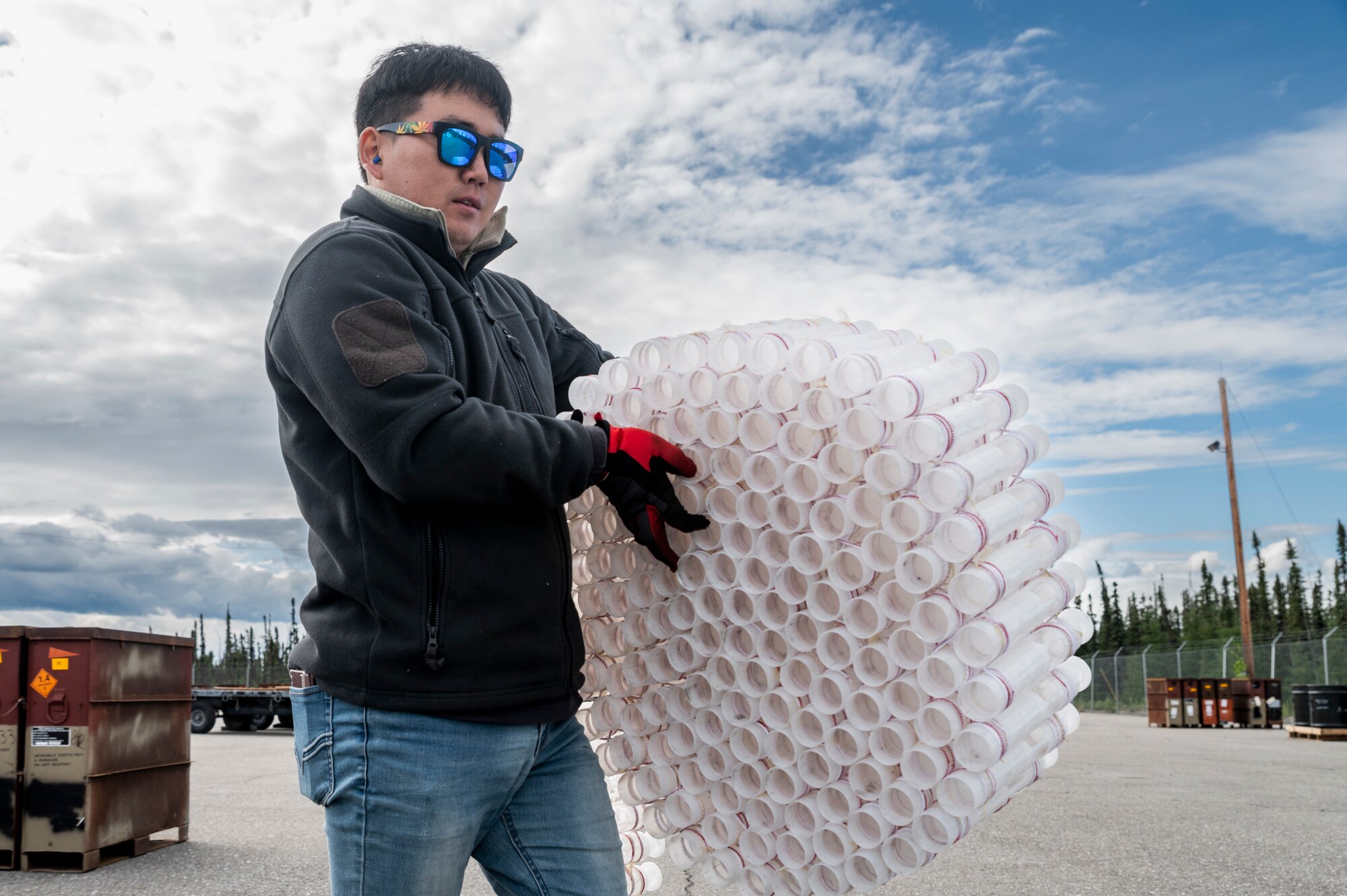 Tong Chu Paek, 51st Munitions Squadron explosive operator renovation technicians, Osan Air Base, Republic of Korea, carries an empty 30mm round belt during Red Flag Alaska (RF-A) 23-2 at Eielson Air Force Base, Alaska, June 12, 2023.