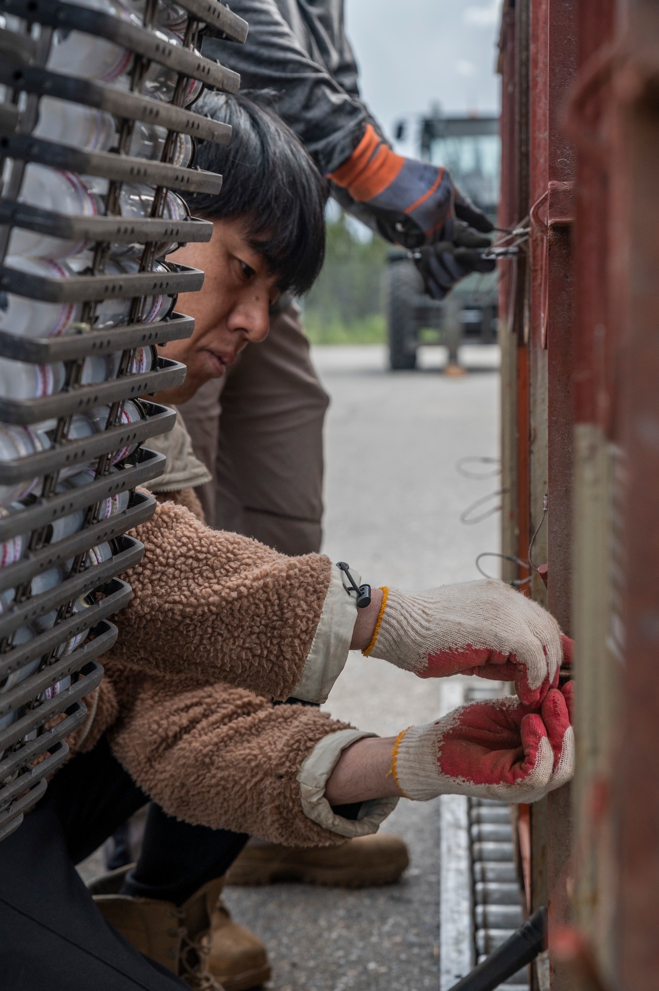 Chin U. Kim, 51st Munitions Squadron explosive operator renovation technicians, Osan Air Base, Republic of Korea, opens a container filled with 30mm rounds during Red Flag Alaska (RF-A) 23-2 at Eielson Air Force Base, Alaska, June 12, 2023.