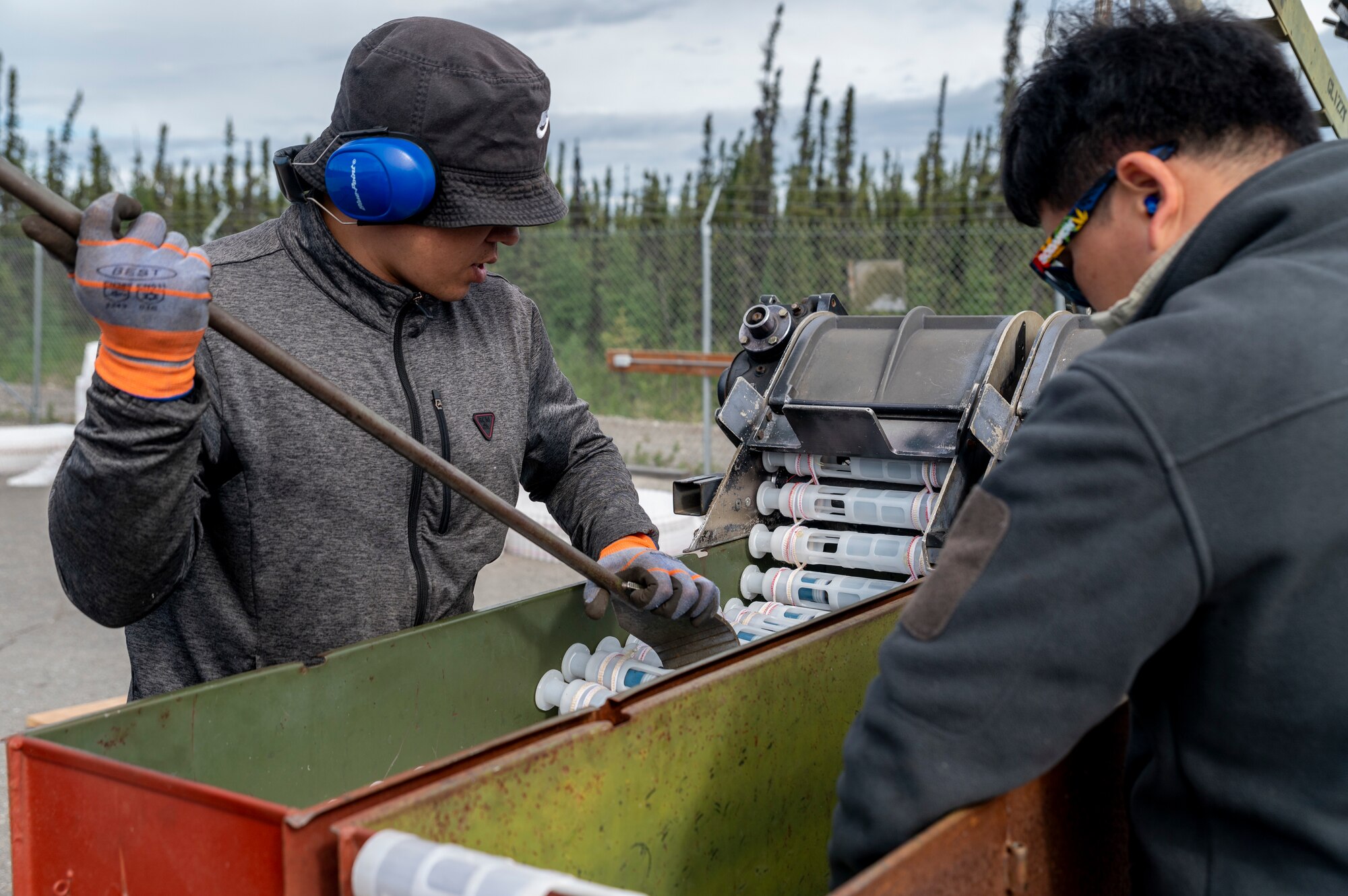 ong Chu Paek and Jin Choi, 51st Munitions Squadron explosive operator renovation technicians, Osan Air Base, Republic of Korea, operate a 30mm munitions loader during Red Flag Alaska (RF-A) 23-2 at Eielson Air Force Base, Alaska, June 12, 2023.