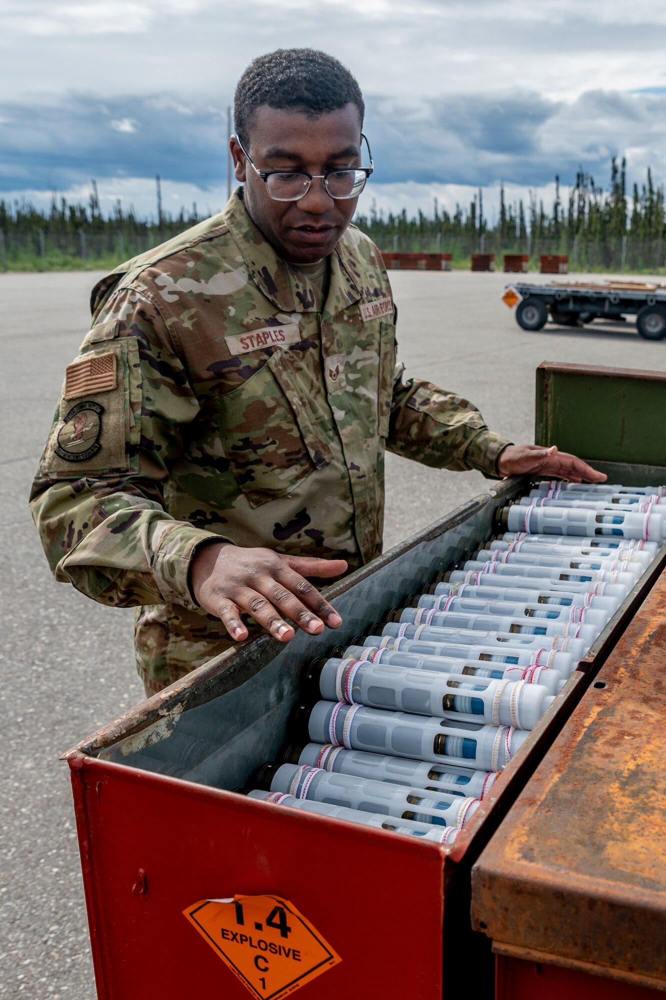 U.S. Air Force Staff Sgt. Darius Staples, 51st Munitions Squadron munitions crew chief from Osan Air Base, Republic of Korea, inspects a container filled with 30mm rounds during Red Flag Alaska 23-2 at Eielson Air Force Base, Alaska, June 12, 2023.