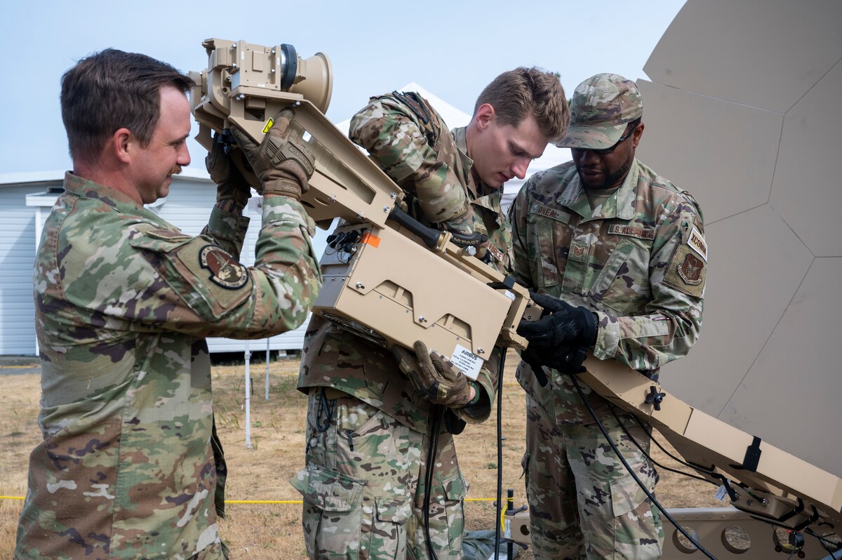 55th and 35th Combat Communications Squadron Airman replace a feed boom on a Ranger 2400 Flyaway Multi-Band Terminal.