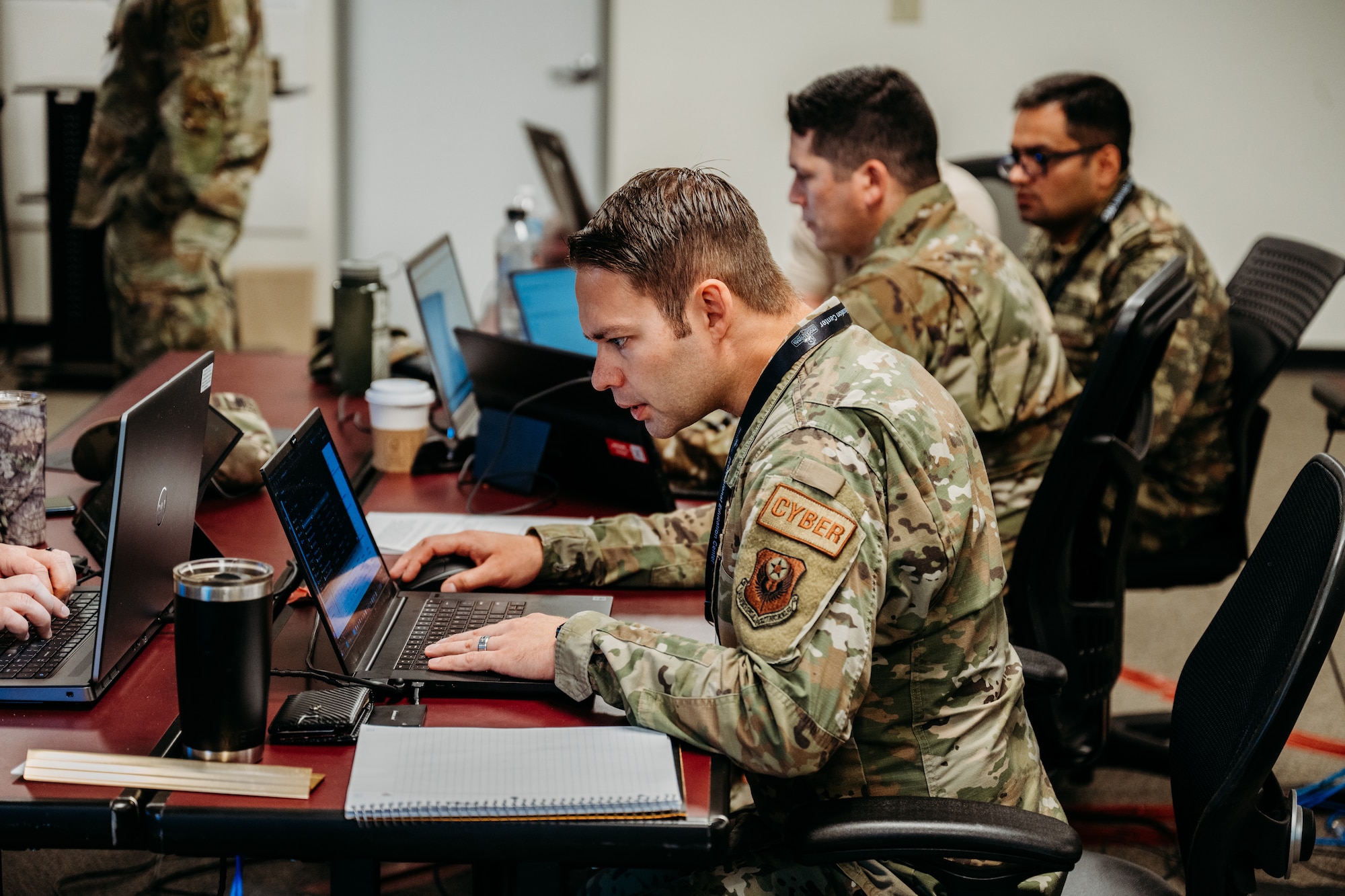 Members of the Oklahoma National Guard cybersecurity team work together to defend networks during Cyber Shield 2023, held at the Professional Education Center in Little Rock, Arkansas, June 10, 2023. With technology continuing to advance at an unprecedented pace along with its associated threats, members of the Oklahoma National Guard joined approximately 800 military and civilian cyber professionals from 35 states, including international partners, for this year’s Cyber Shield, June 2-16, 2023. This year's exercise, won by the Oklahoma team for the second year in a row, was centered on critical infrastructure protection, incident response, network defense with a specific tie to U.S. Transportation Systems Sector and other crucial aspects of cybersecurity. (Oklahoma National Guard photo by Master Sgt. Mireille Merilice-Roberts)