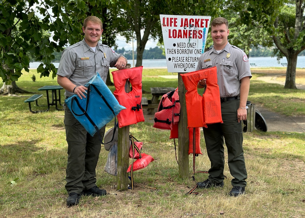 Old Hickory Park Rangers Jakob Craig and Britton Dillard hang lifejackets and floatation mats for visitors to borrow while recreating June 22, 2023, at Old Hickory Lake in Hendersonville, Tennessee. (USACE Photo by: Misty Cunningham)