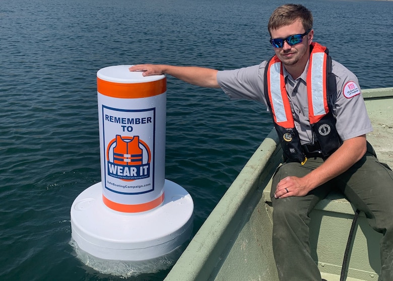 Lake Cumberland Park Ranger Dylan Norton helps to strategically place buoys June 22, 2023, with the slogan, “remember to wear it,” in hopes that visitors will follow the advice and wear life jackets to help keep them safe while recreating at Lake Cumberland in Somerset, Kentucky. (USACE Photo)