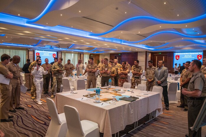 Multinational participants of the Multilateral Maritime Engagement (MME) 23.2 conference in Bahrain discuss future bilateral training ideas, June 26, 2023. MME is a Task Force 51/5-led event that fosters multilateral communication, security cooperation, and future collaborative training between partners in the U.S. Central Command area of responsibility. (U.S. Marine Corps photo by Staff Sgt. Victor Mancilla)