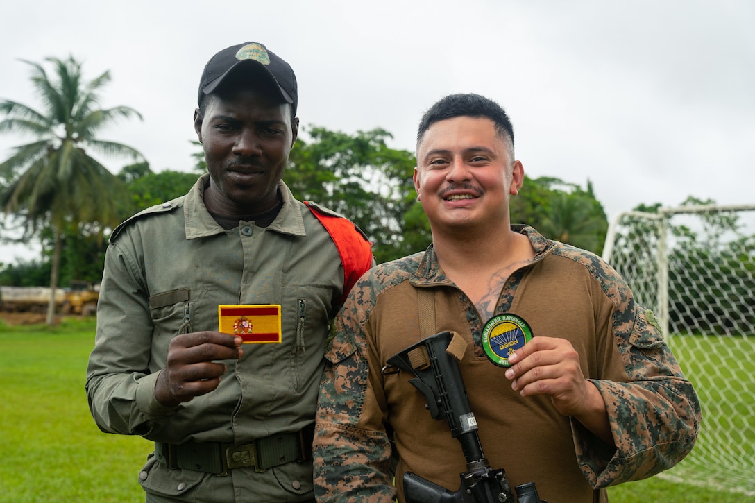 A U.S. Marine and a member of the Gabonese Republican Guard pose for a photo.