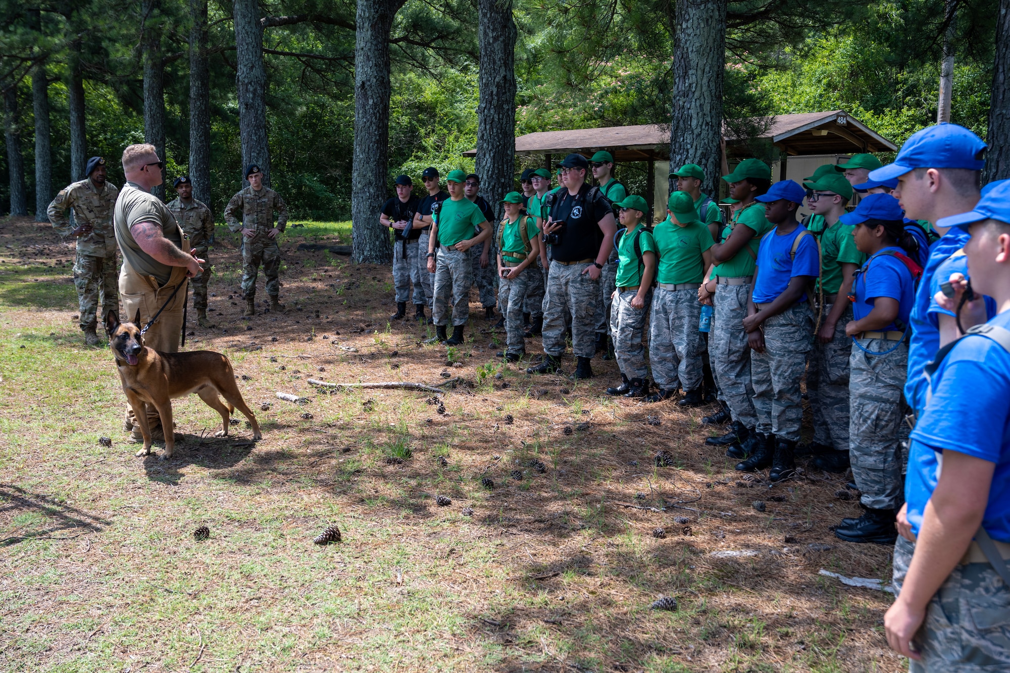 A male Airman speaks to Civil Air Patrol cadets with his military working dog Harry