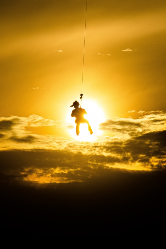 A U.S. Navy explosive ordinance disposal technician rappels from a CV-2 Osprey