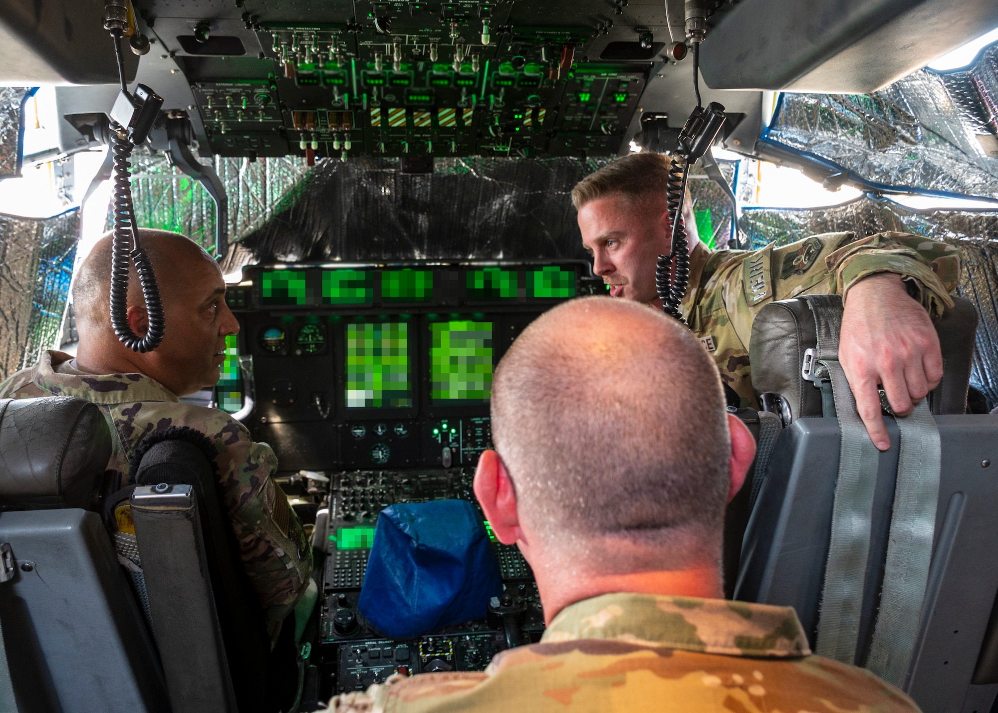 A U.S. Air Force service member briefs U.S. Air Force Brig. Gen. Gandhi, 378th Air Expeditionary Wing commander, on the capabilities of the C-130 Aircraft and the utilization in airdrop and aeromedical evacuation missions.