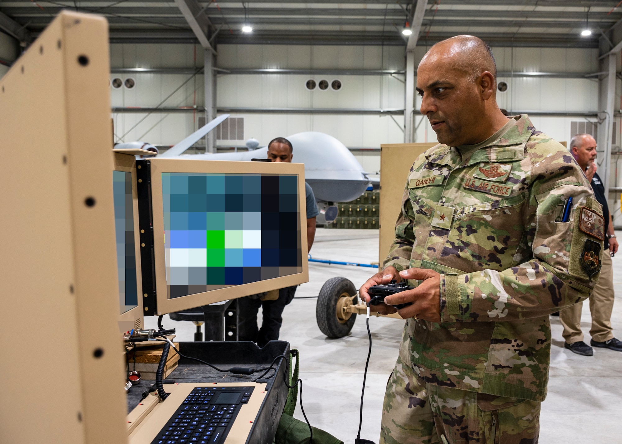 U.S. Air Force Brig. Gen. Akshai Gandhi, 378th Air Expeditionary Wing commander, visited the 46th Expeditionary Attack Squadron and reviewed ancillary data from MQ-9 aircraft while being briefed on Satellite Launch and Recovery (SLR) operations.