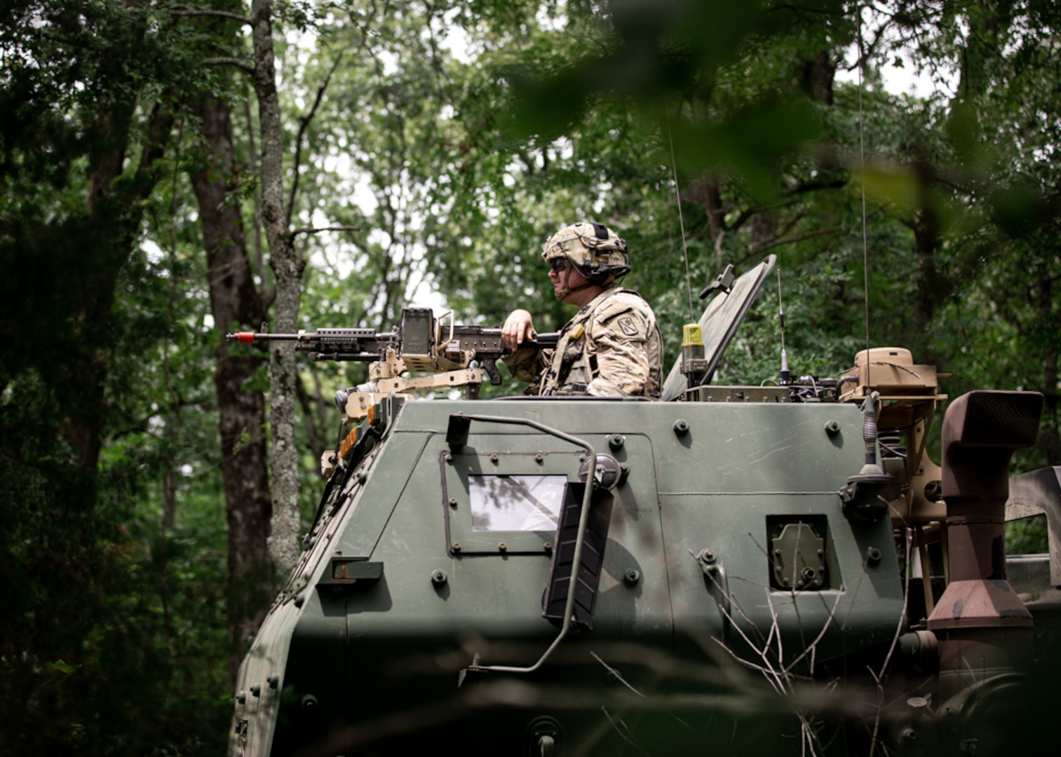 An Oklahoma Army National Guard Soldier with the 45th Field Artillery Brigade, provides security from the turret of a High Mobility Artillery Rocket System during exercise Western Strike at Fort Chaffee, Arkansas, June 21, 2023. Western Strike is a highly immersive and fully instrumented training comparable to a combat training center that aims to prepare units like the 45th FAB for overseas operations. (Oklahoma National Guard photo by Spc. Danielle Rayon)