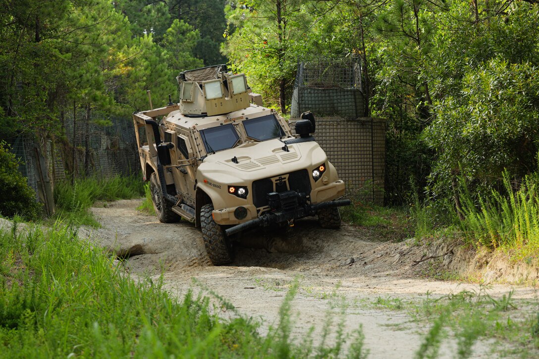U.S. Marines with the 2nd Marine Logistics Group Motor Vehicle Incidental Driving School (MVIDS) drive a joint light tactical vehicle through a ditch on the Combat Vehicle Operations Training (CVOT) Range on Camp Lejeune, North Carolina, June 16, 2023. Marines with MVIDS train Marine student vehicle operators on the CVOT range to build confidence in the student’s abilities to conquer obstacles, maneuver through rough terrain and instill trust in their vehicles capabilities. (U.S. Marine Corps photo by Lance Cpl. Mary Kohlmann)