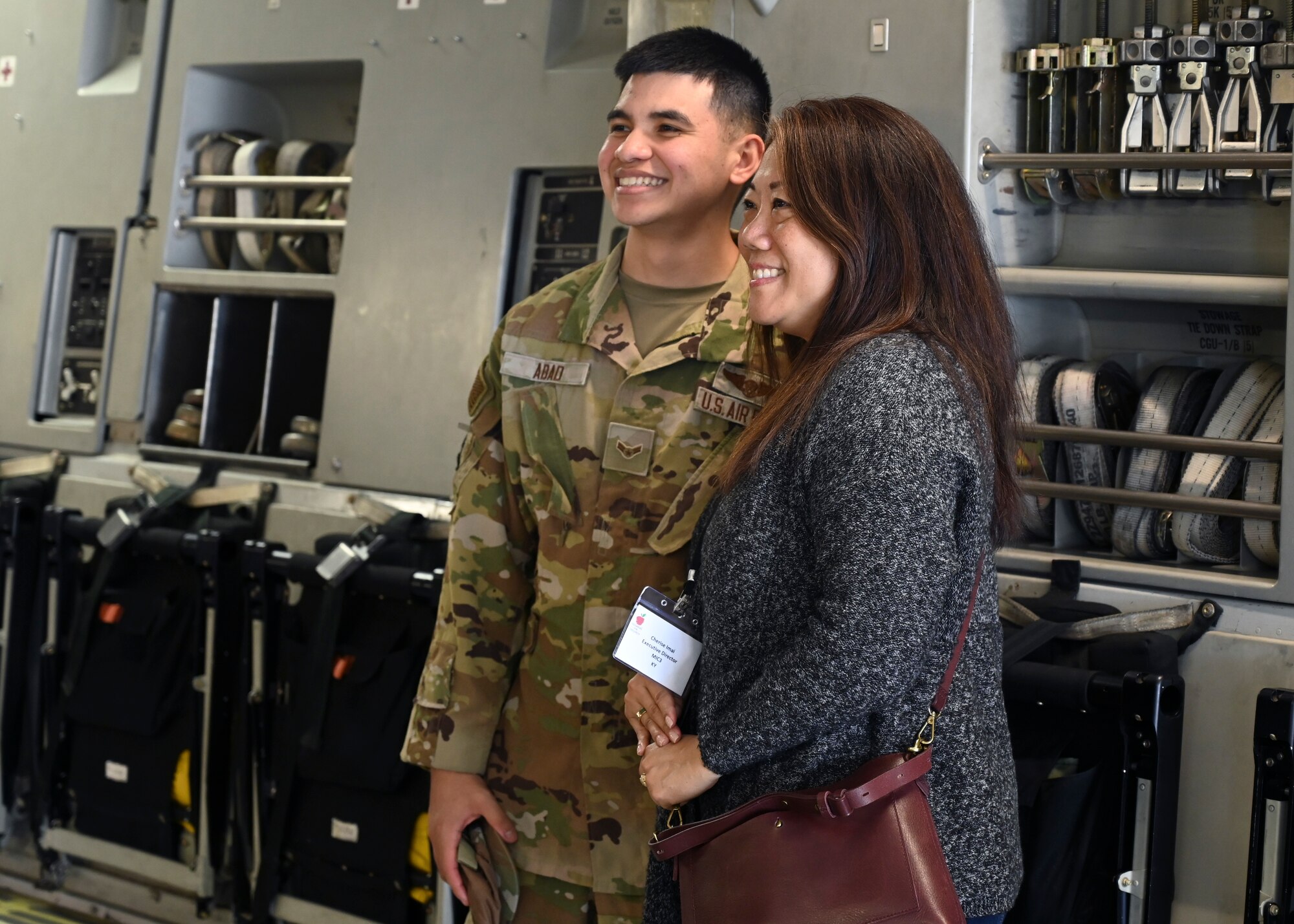U.S Air Force Senior Airman Aydan Abad, loadmaster with the 7th Airlift Squadron, poses for a photo with a member of the Military Impacted Schools Association on a C-17 Globemaster III at Joint Base Lewis-McChord, Washington, June 27, 2023. MISA is a national organization of school superintendents whose mission is to serve school districts with a high concentration of military children. MISA works on funding, legislation, partnerships and programs for military families on the move. Members visited JBLM and were given a mission brief from U.S. Air Force Col. David Morales, 62d Airlift Wing vice commander, and toured a C-17. (U.S. Air Force photo by Senior Airman Callie Norton)