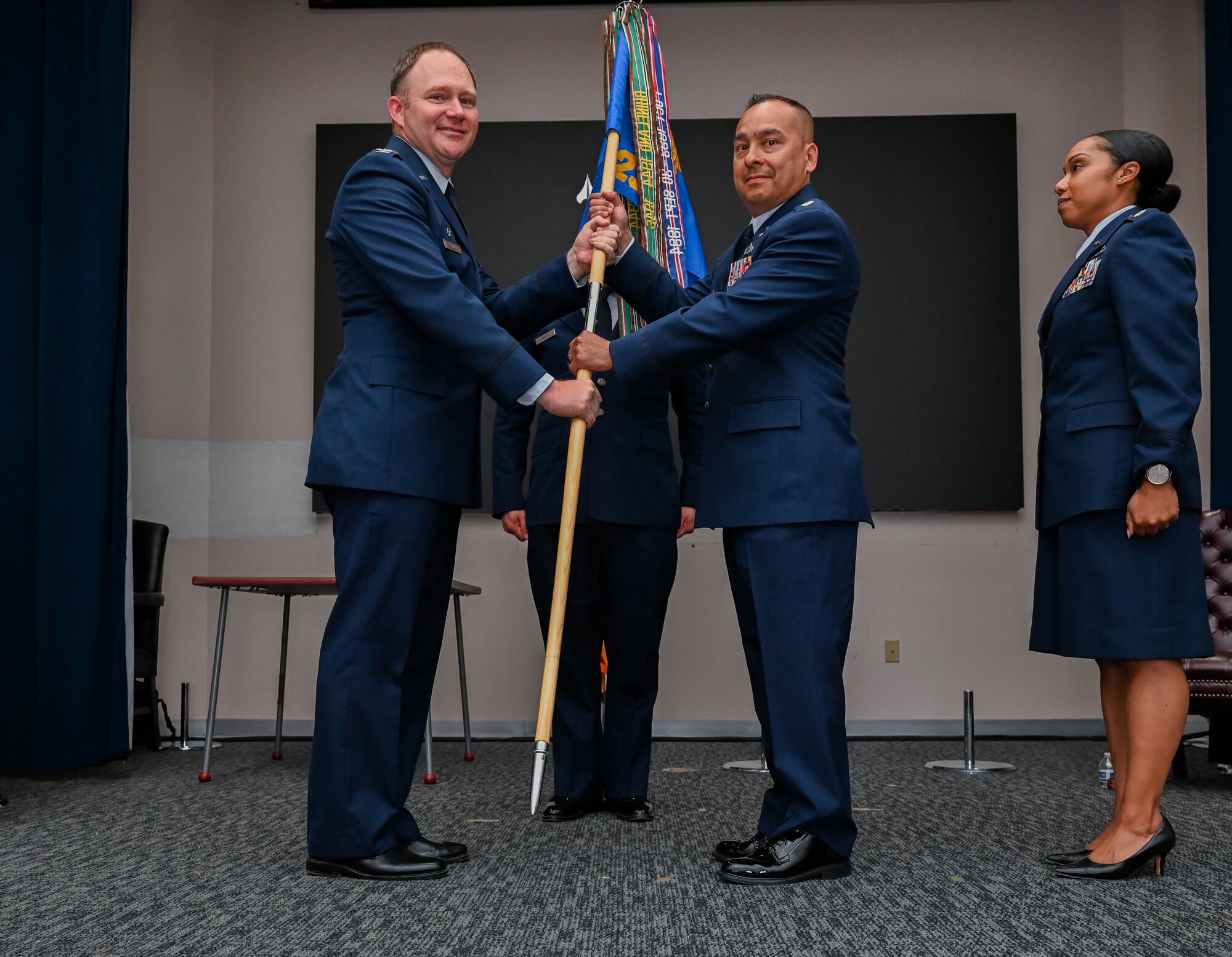 Col. Eric Bernkopf, 655th Intelligence, Surveillance, and Reconnaissance Group commander, presents the 23rd Intelligence Squadron guidon to Lt. Col. Philip Inigo during the 23rd Intelligence Squadron change of command ceremony at Joint Base San Antonio-Lackland, Texas, June 3, 2023. Inigo previously served as the senior intelligence officer for the 310th Space Wing at Schriever Air Force Base, Colorado. (U.S. Air Force photo by Senior Airman Mark Colmenares)
