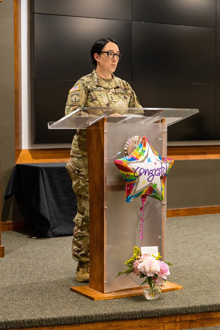 Newly promoted Master Sgt. Erin Connelly speaks to those in attendance during her promotion ceremony at the Illinois Military Academy in Springfield, Illinois, June 6.