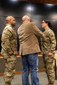 Col. (ret.) Eric Davis “pins” Master Sgt. Erin Connelly with her new rank during a ceremony at the Illinois Military Academy in Springfield, Illinois, June 6.