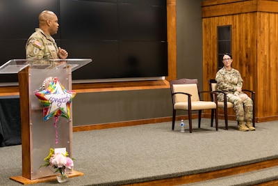 Lt. Col. Jason Carter congratulates Master Sgt. Erin Connelly on her promotion during a ceremony at the Illinois Military Academy in Springfield, Illinois, June 6.