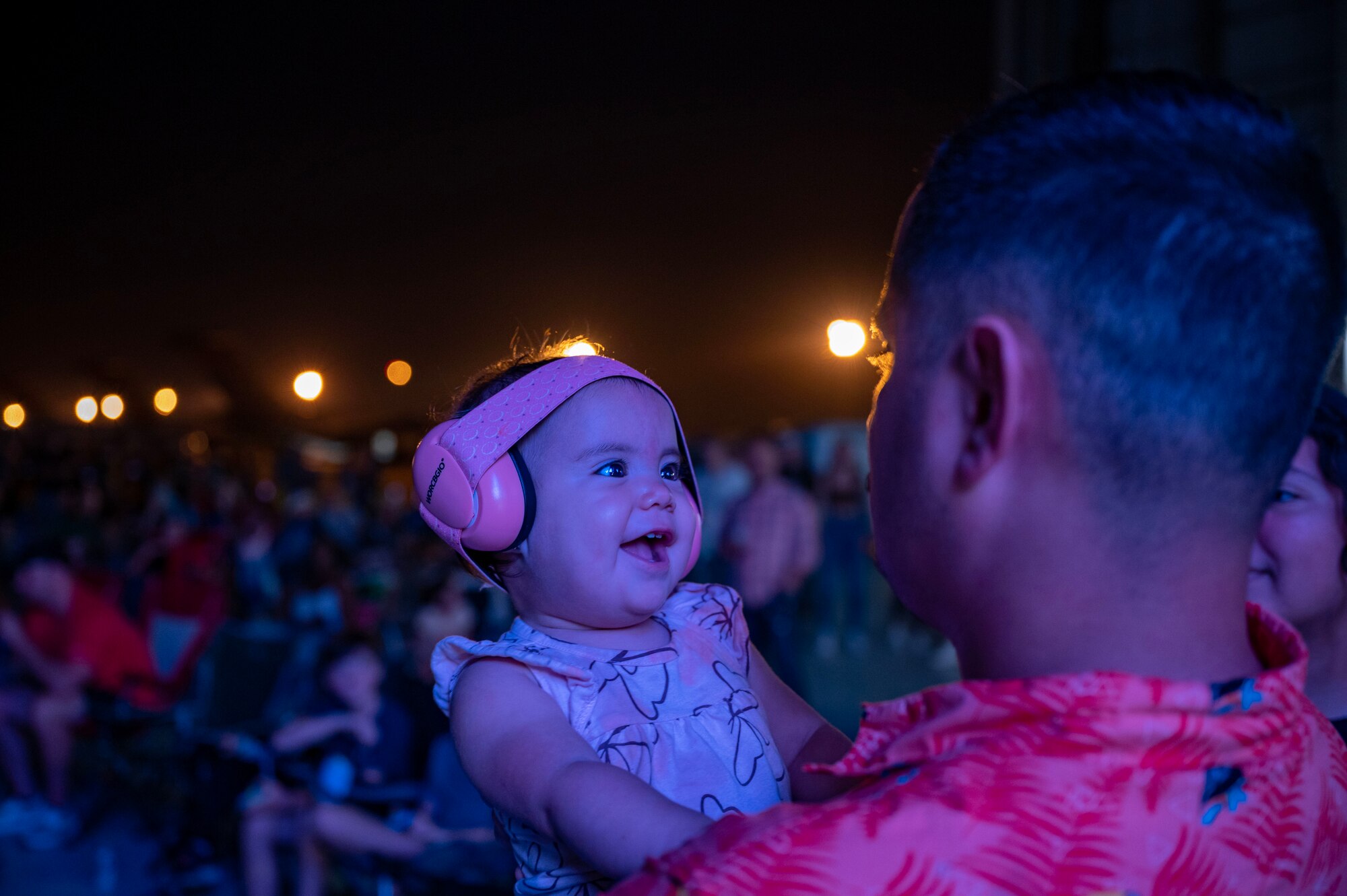 A young Team Dover member smiles as Rodney Atkins, an American country music artist, performs during Freedom Fest at Dover Air Force Base, Delaware, June 22, 2023. Freedom Fest, hosted by Air Force Entertainment Live Stage, was free to Department of Defense card holders and featured opening act Ryan Daniel, support act Lonestar and headliner Rodney Atkins. (U.S. Air Force photo by Airman 1st Class Amanda Jett)