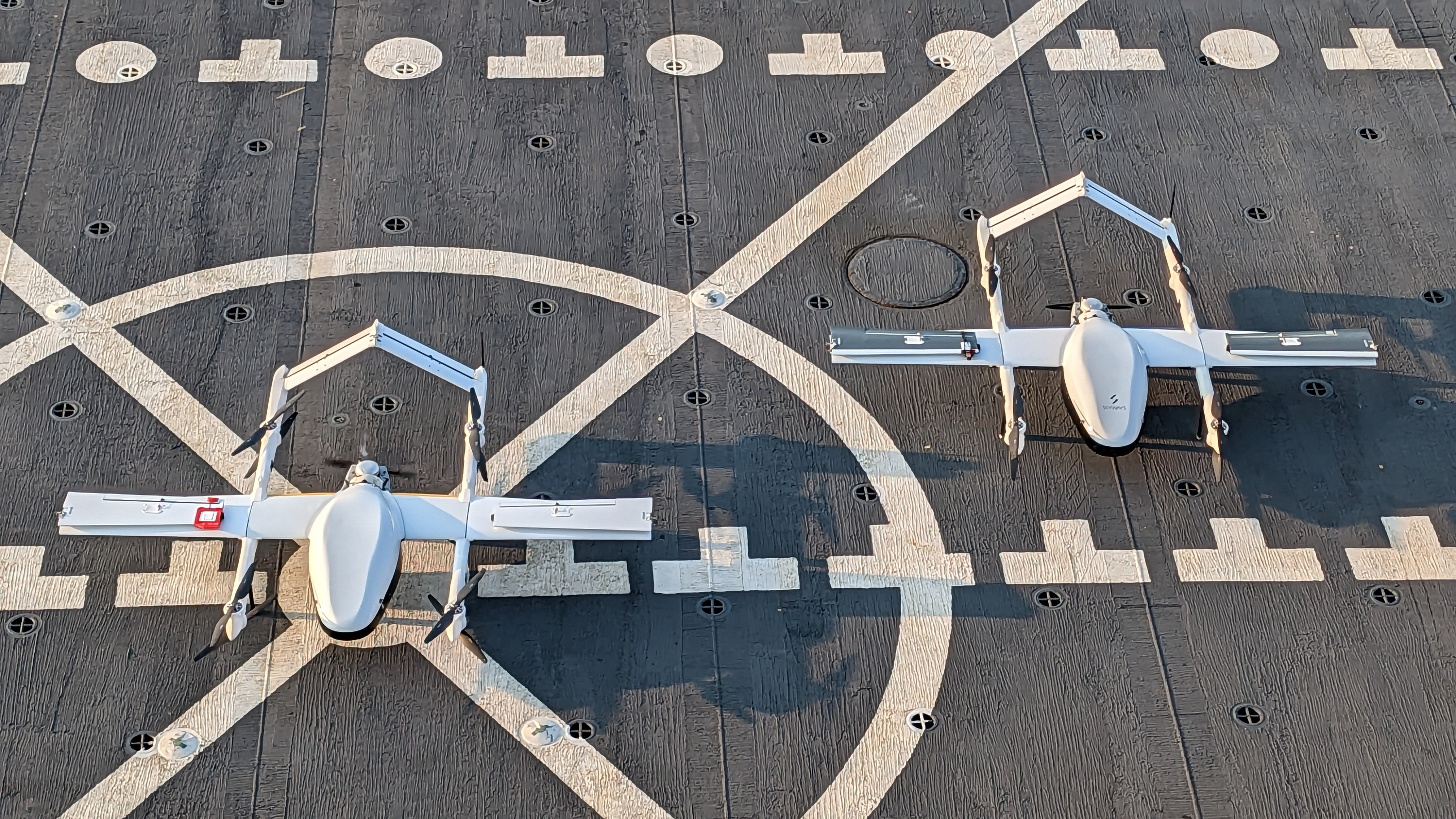 A view of two Blue Water Logistic Unmanned Areal System on the flight deck of the fleet replenishment oiler USNS Patuxent (T-AO 201) while the ship was underway in the Atlantic Ocean, June 10.