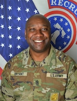 Soldier in uniform in front of United States flag and Recruiting Command flag