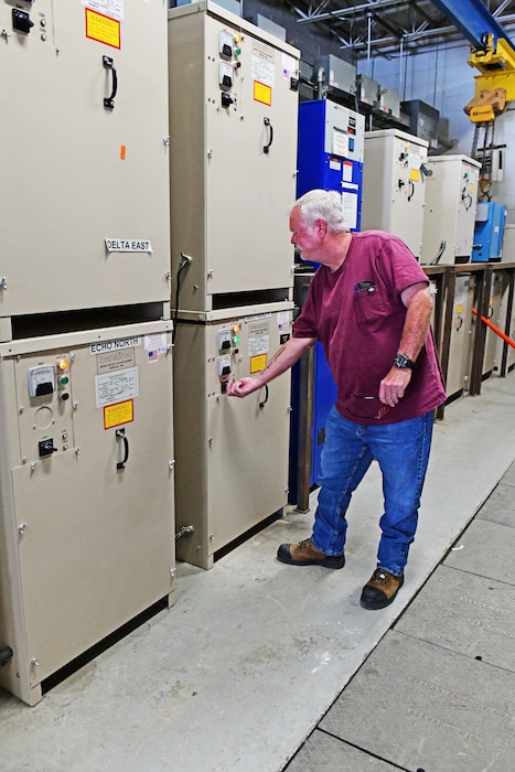 Man turning a breaker switch