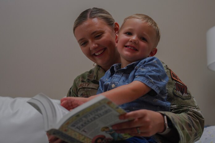U.S. Air Force Staff Sgt. Morgan Hasty, 553rd Intelligence Squadron intelligence analyst, reads a book to her son, May 31, 2023, at Beale Air Force Base, California.