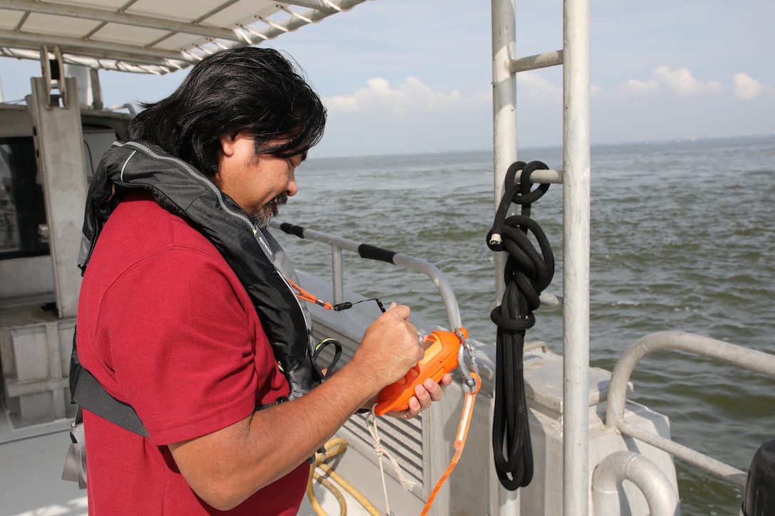 Jasper Schaer, Hydro Survey Team, U.S. Army Corps of Engineers Galveston District,checks a GPS sounding tool prior to beginning a post dredge survey. Calibrating sonar instruments to local water quality is an important part of taking accurate measurements. Sounding measures the speed at which the single beam sonar waves pass through the water. Those sound waves are measured and recorded aboard the survey vessel, Tanner II. When a large ship passes, it disturbs sediment which slows down the sonar signal. With the heavy traffic in the Houston Shipping Channel, Schaer performs frequent sounding checks to ensure precise measurement of dredge material removed. Schaer and other survey crew members like him perform surveys before and after a dredging contract and after dredged sand is deposited offshore.